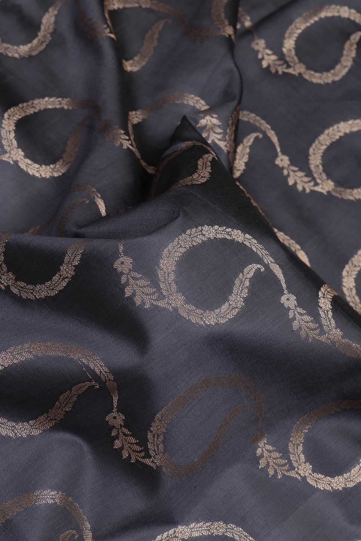 Close up of Grey Dual Tone Tussar Silk Saree with Zari Brocade on the body and Zari Border.  displaying folds