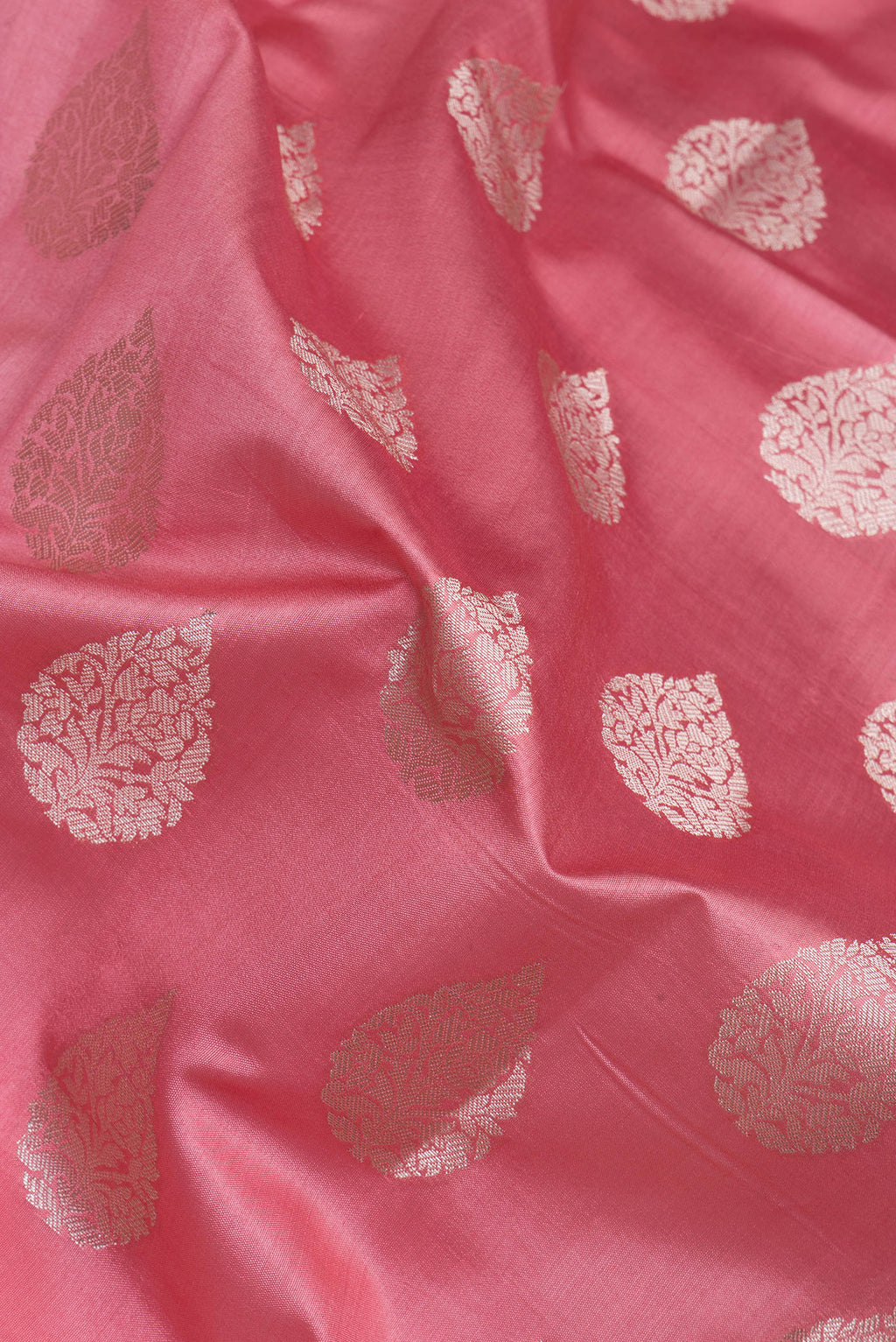 Close up of Pink Tussar Silk Saree with Zari Butta on the body and Zari Border.  displaying folds