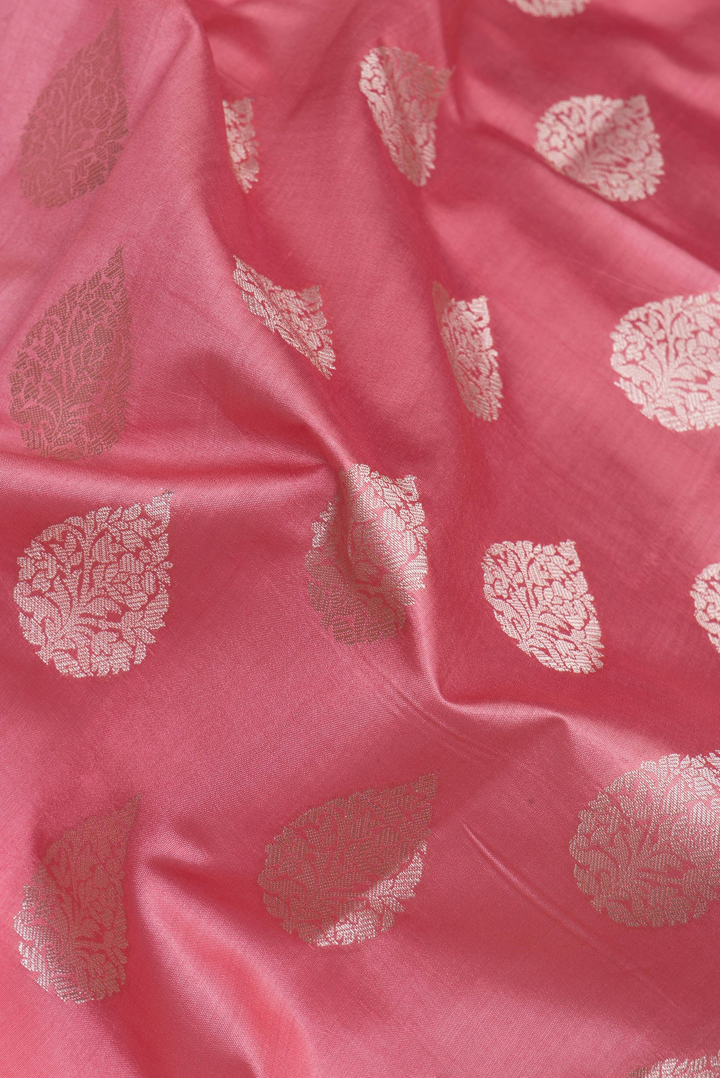 Close up of Pink Tussar Silk Saree with Zari Butta on the body and Zari Border.  displaying folds