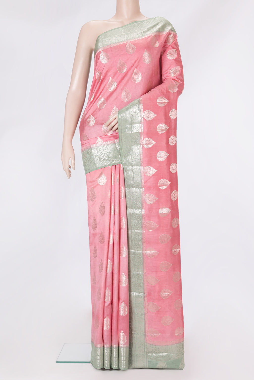 Pink Tussar Silk Saree with Zari Butta on the body and Zari Border.  displayed on a mannequin