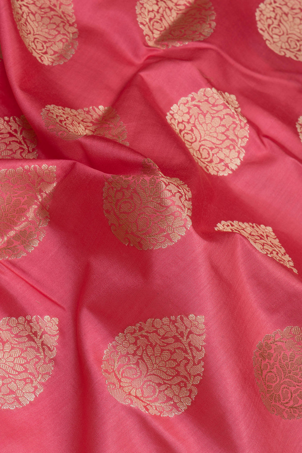 Close up of Pink Tussar Silk Saree with Zari Butta on the body and Zari Border.  displaying folds