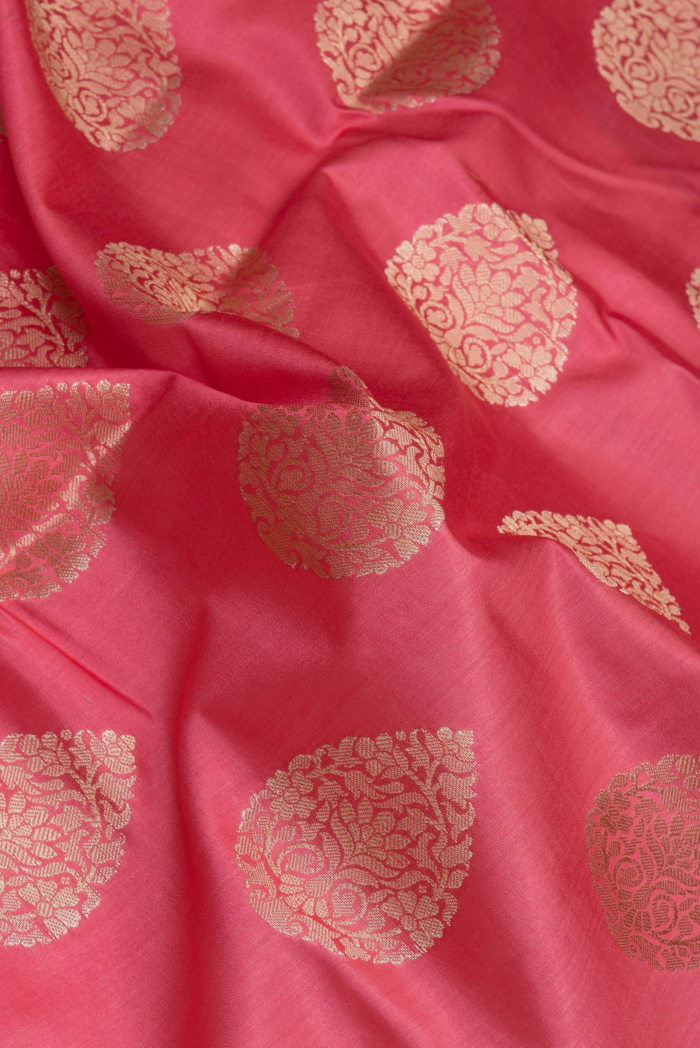 Close up of Pink Tussar Silk Saree with Zari Butta on the body and Zari Border.  displaying folds
