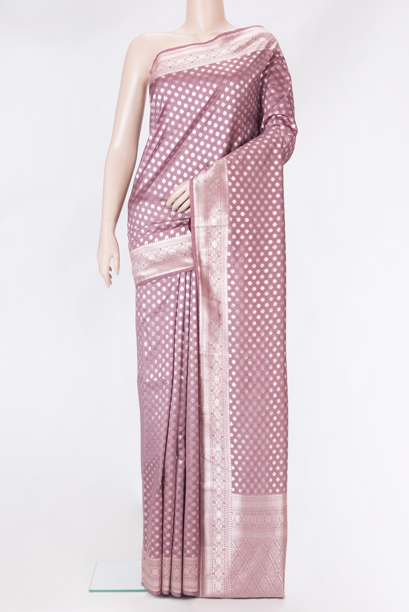 Mauve Tussar Silk Saree with Zari Butta on the body and Zari Border.  displayed on a mannequin