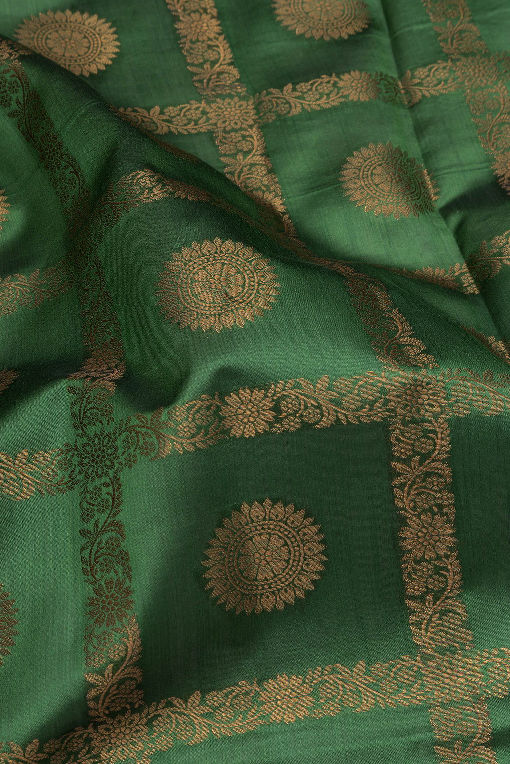 Close up of Green Tussar Silk Saree with Checked design on the body and Thread Border.  displaying folds