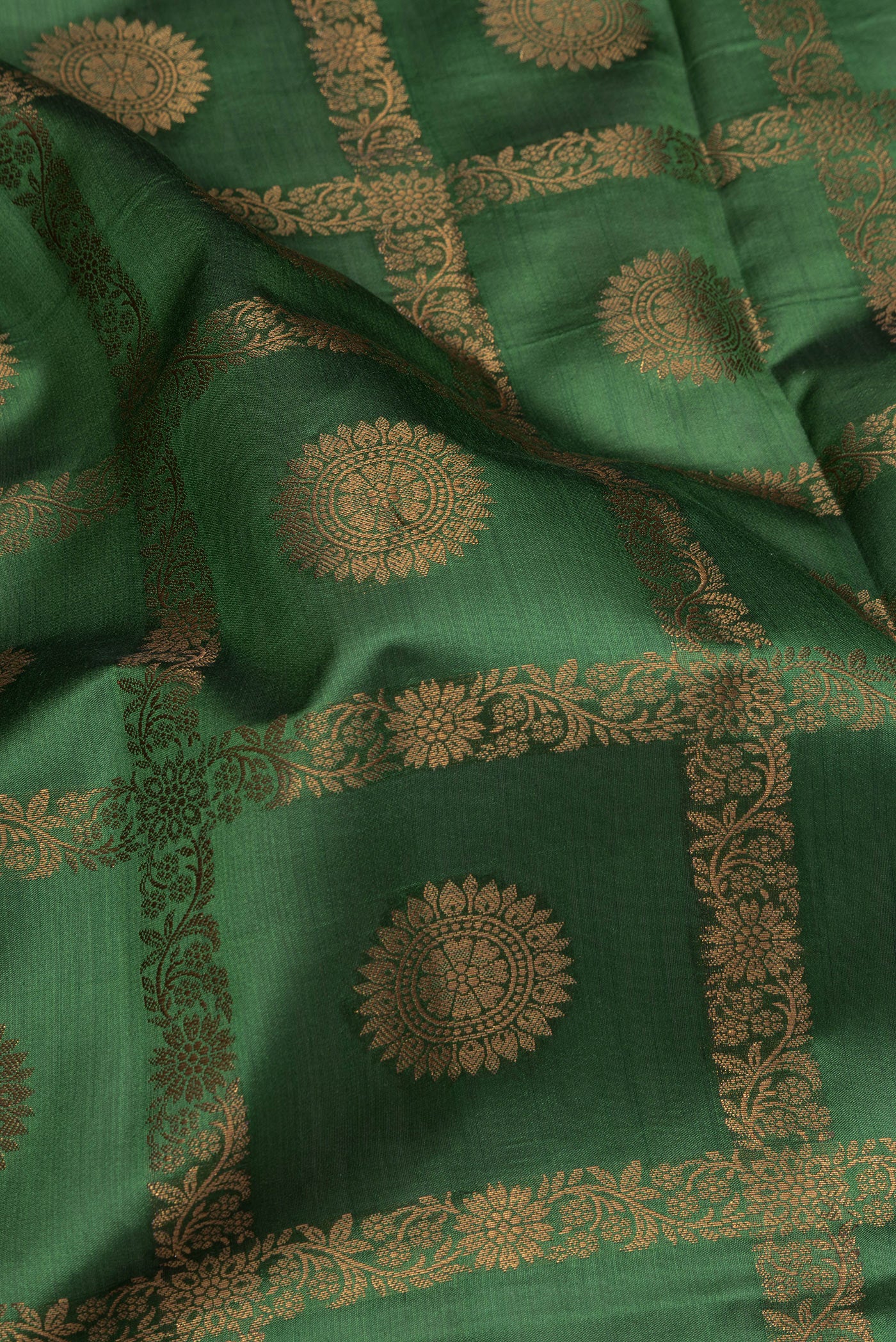 Close up of Green Tussar Silk Saree with Checked design on the body and Thread Border.  displaying folds