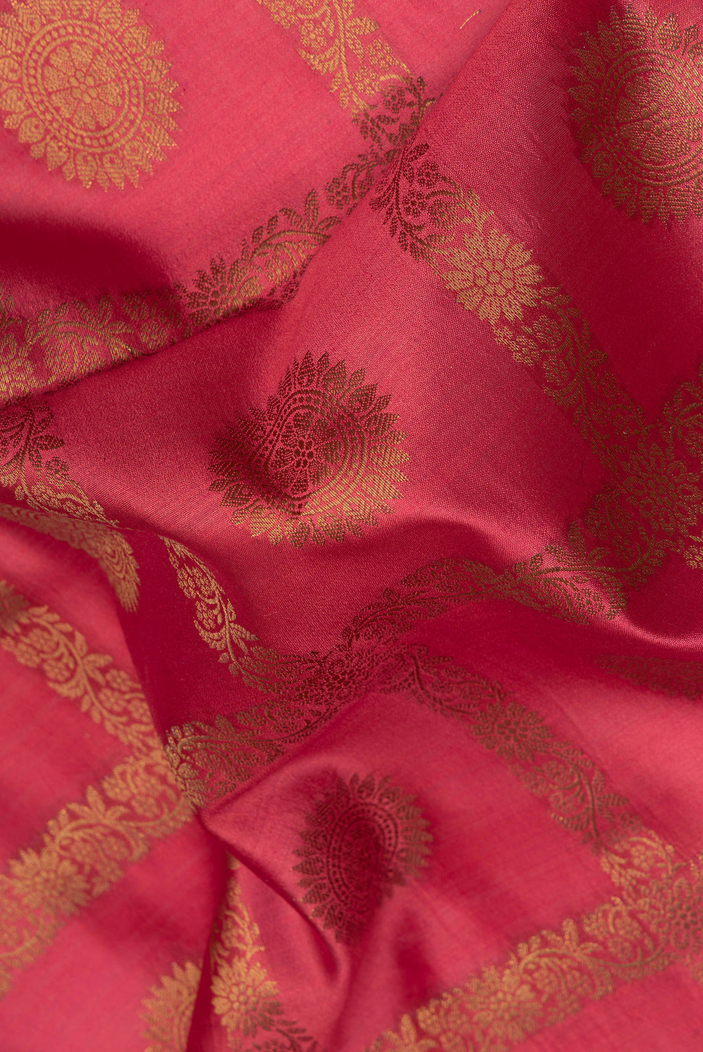 Close up of Maroon Tussar Silk Saree with Zari Butta on the body and Zari Border.  displaying folds