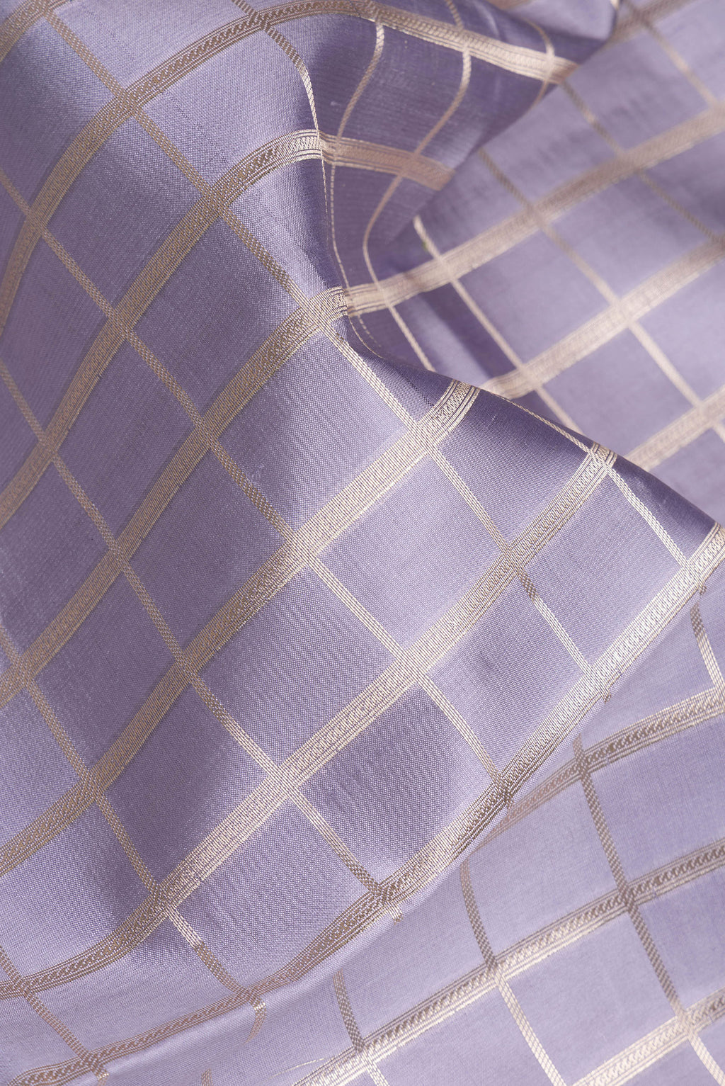 Close up of Grey Dual Tone Tussar Silk Saree with Checked design on the body and Zari Border.  displaying folds