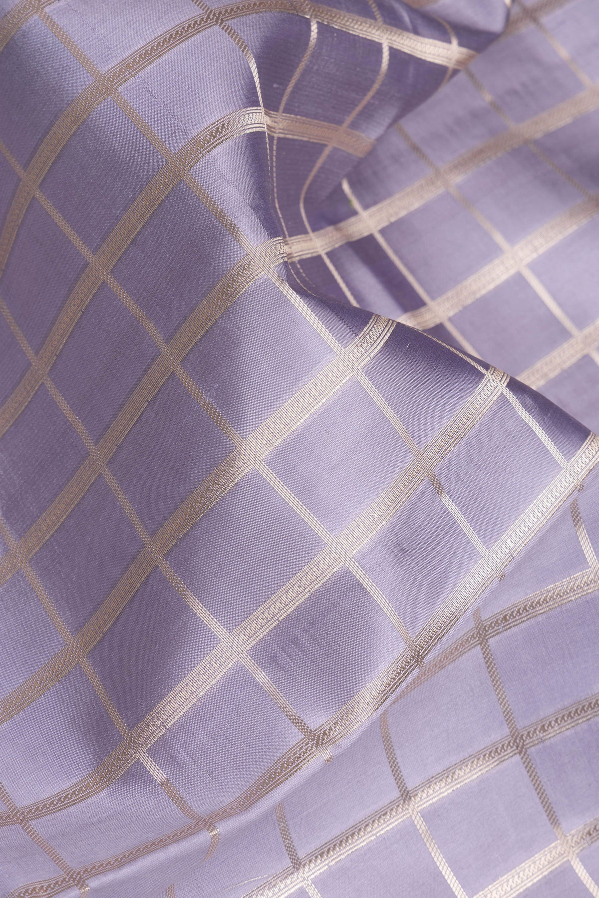 Close up of Grey Dual Tone Tussar Silk Saree with Checked design on the body and Zari Border.  displaying folds