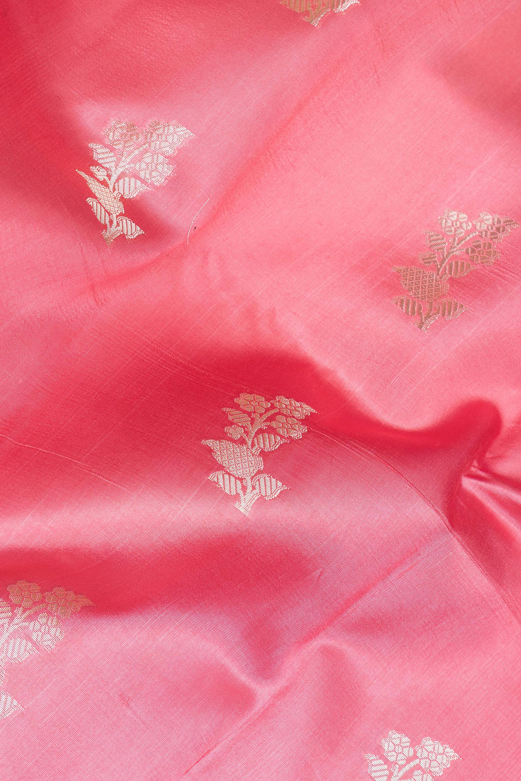 Close up of Pink Tussar Silk Saree with Zari Butta on the body and Zari Border.  displaying folds