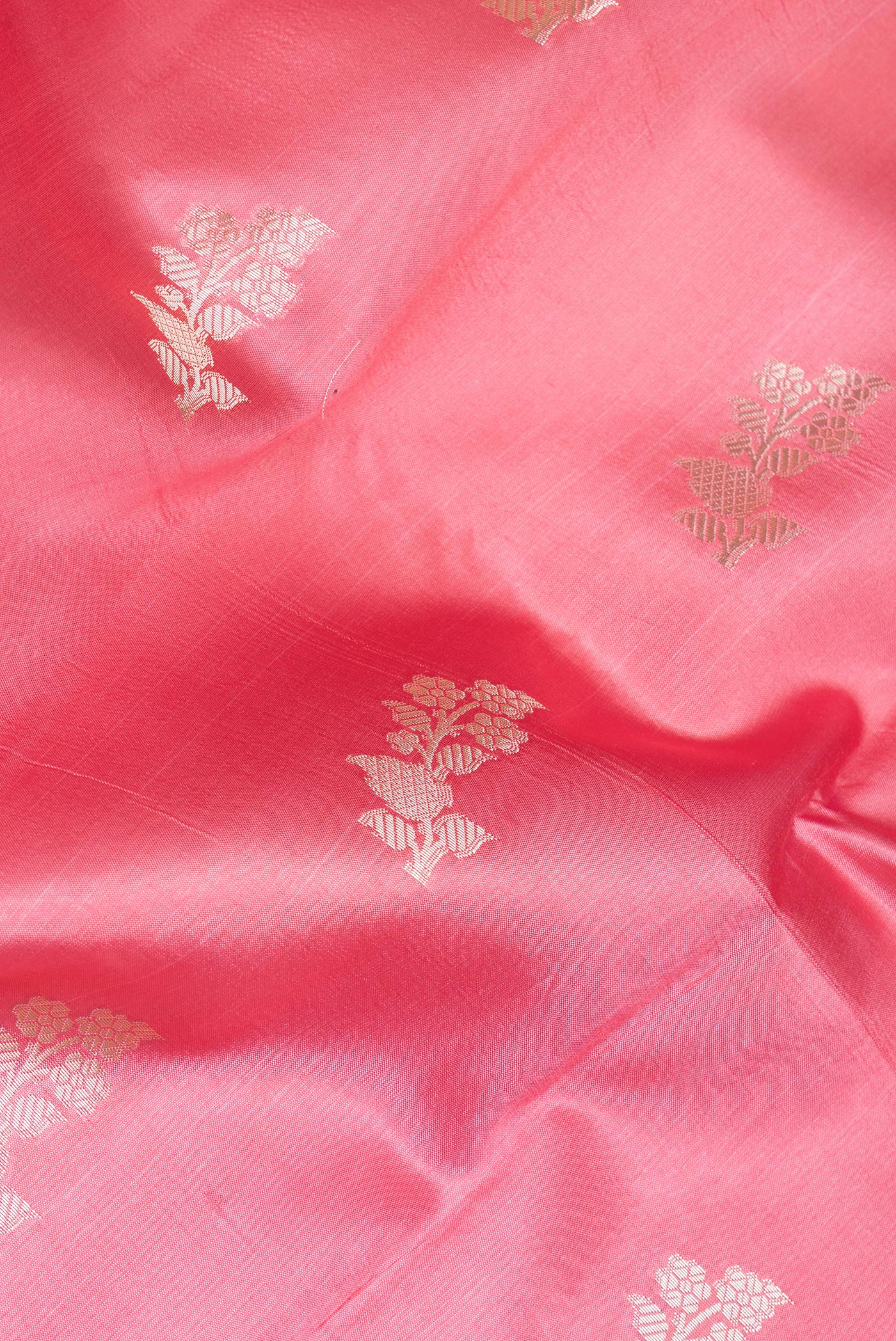 Close up of Pink Tussar Silk Saree with Zari Butta on the body and Zari Border.  displaying folds