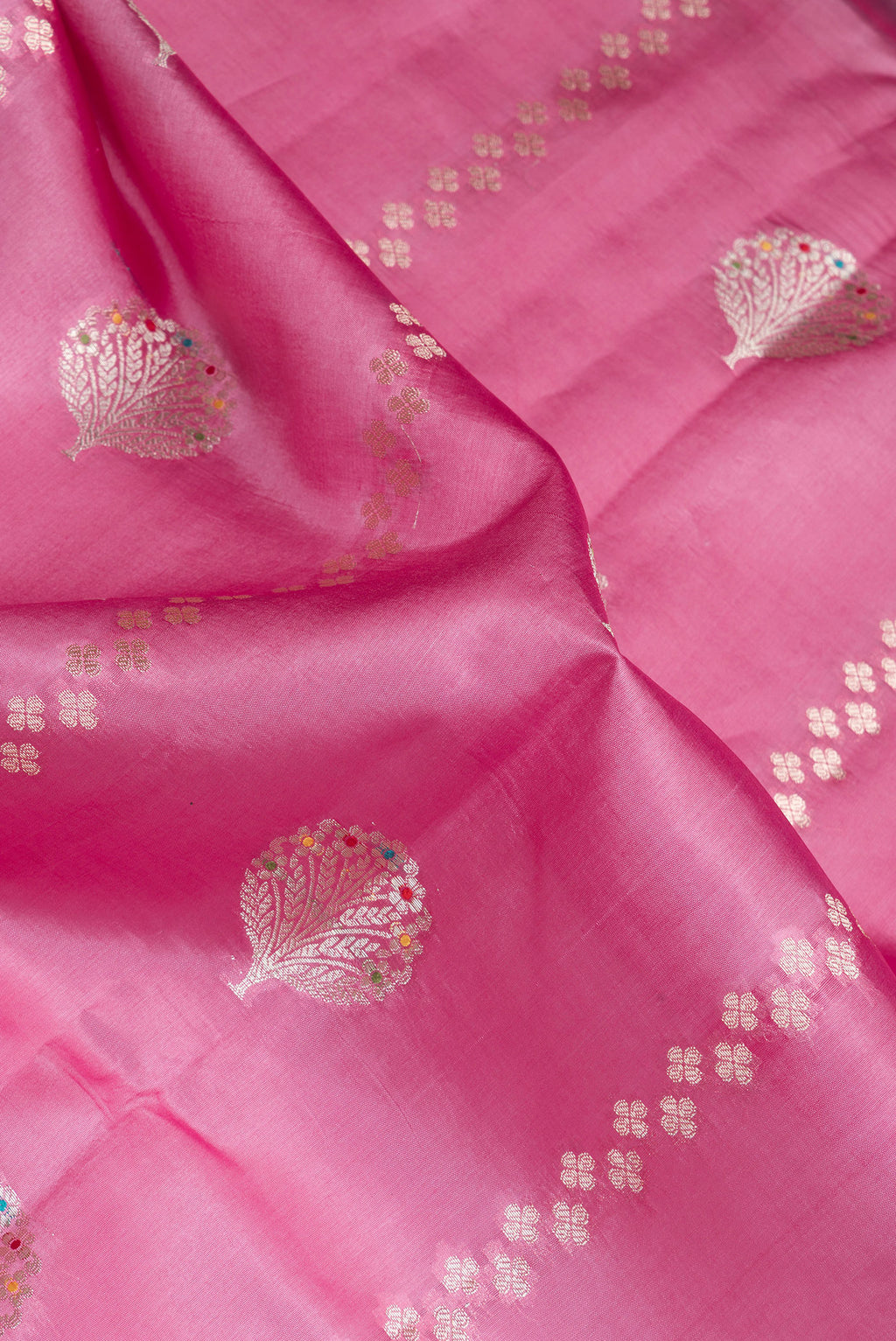 Close up of Pink Dual Tone Tussar Silk Saree with Zari Butta on the body and Fancy Border.  displaying folds