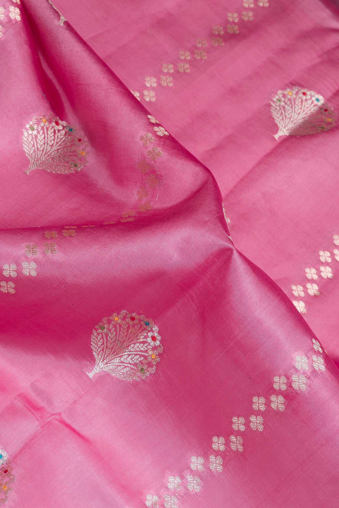 Close up of Pink Dual Tone Tussar Silk Saree with Zari Butta on the body and Fancy Border.  displaying folds