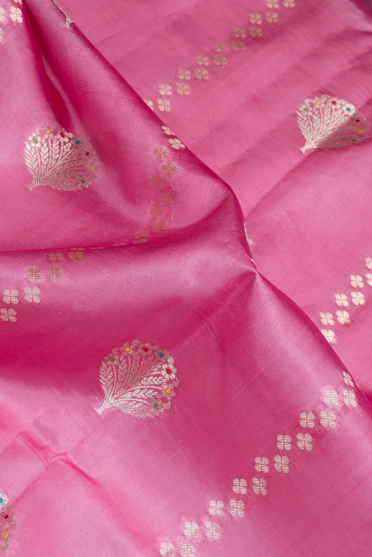 Close up of Pink Dual Tone Tussar Silk Saree with Zari Butta on the body and Fancy Border.  displaying folds