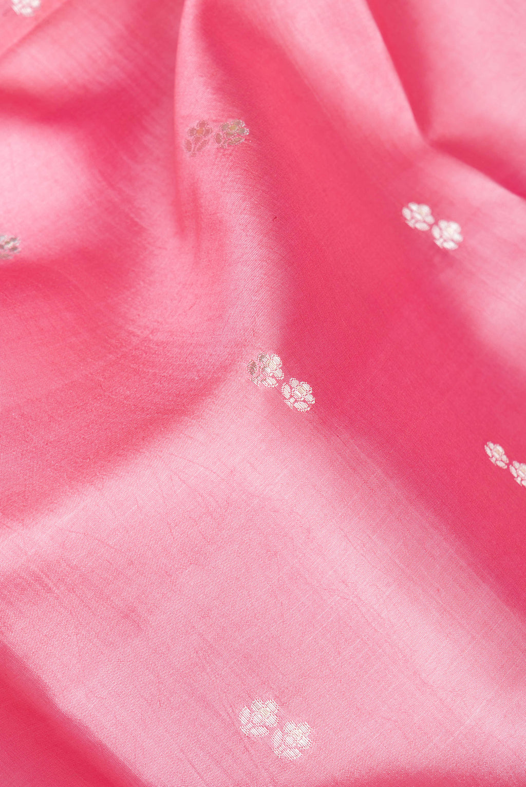 Close up of Pink Tussar Silk Saree with Zari Butta on the body and Fancy Border.  displaying folds