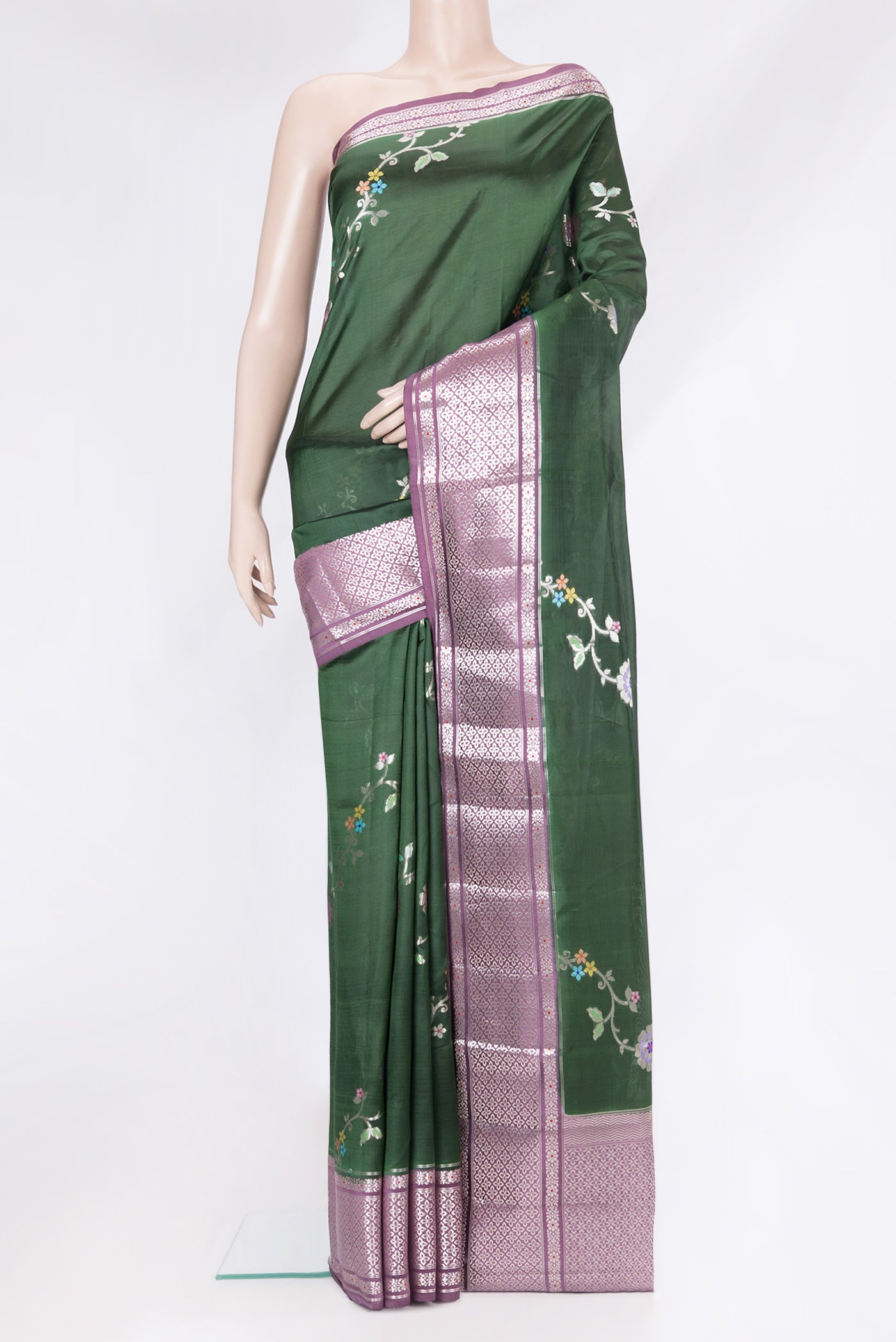 Bottle Green Tussar Silk Saree with Zari Butta on the body and Fancy Border.  displayed on a mannequin
