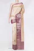 Beige Tussar Silk Saree with Zari And Thread Butta on the body and Zari Border.  displayed on a mannequin