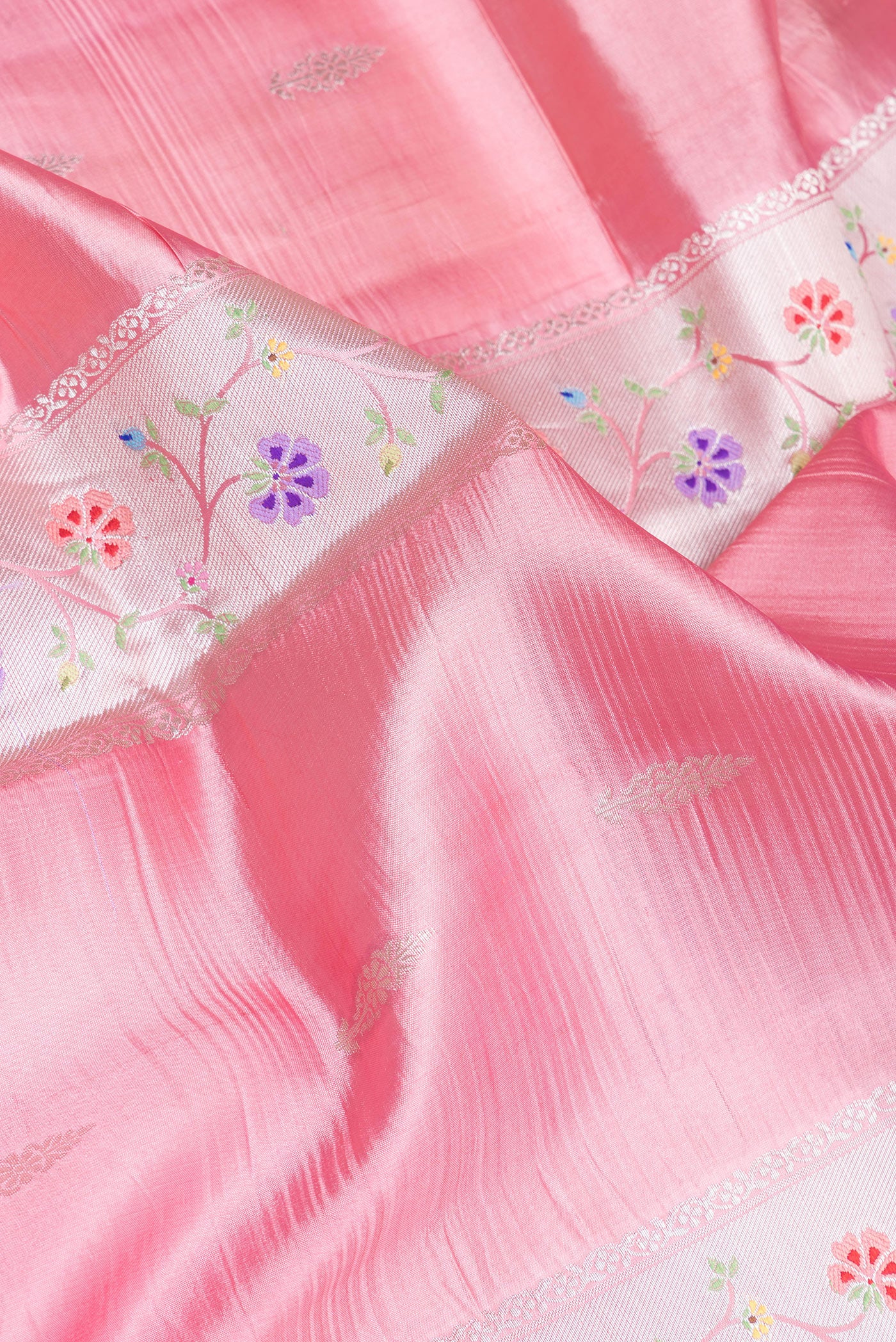 Close up of Pink Dual Tone Tussar Silk Saree with Zari Butta on the body and Zari Border.  displaying folds