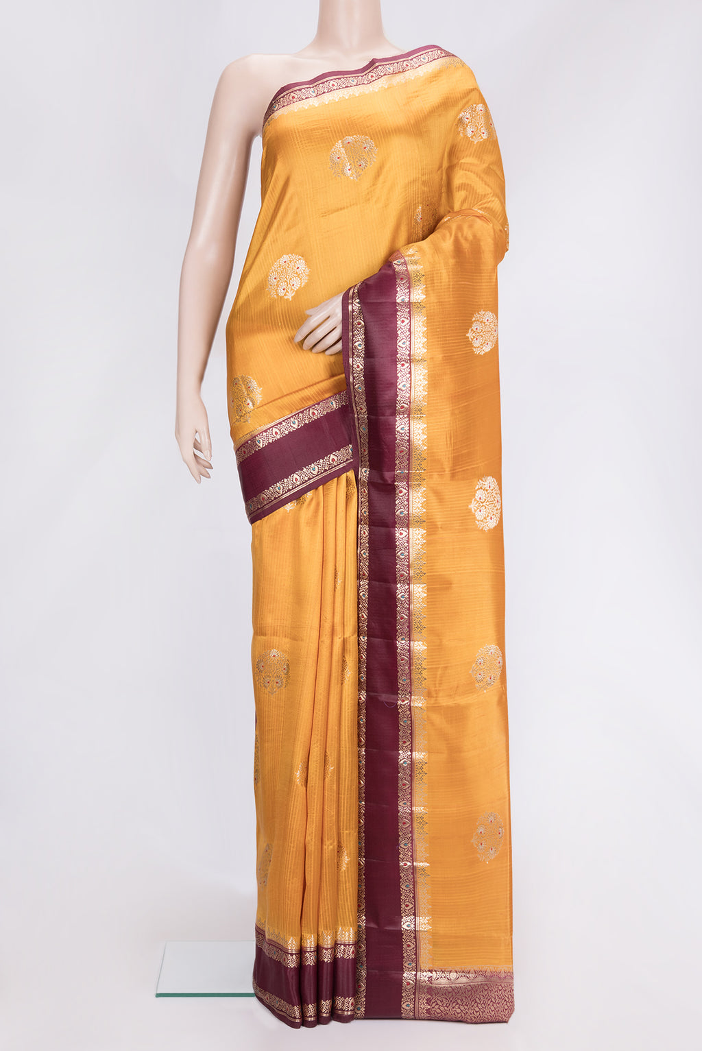Mustard Dual Tone Tussar Silk Saree with Zari Butta on the body and Fancy Border.  displayed on a mannequin