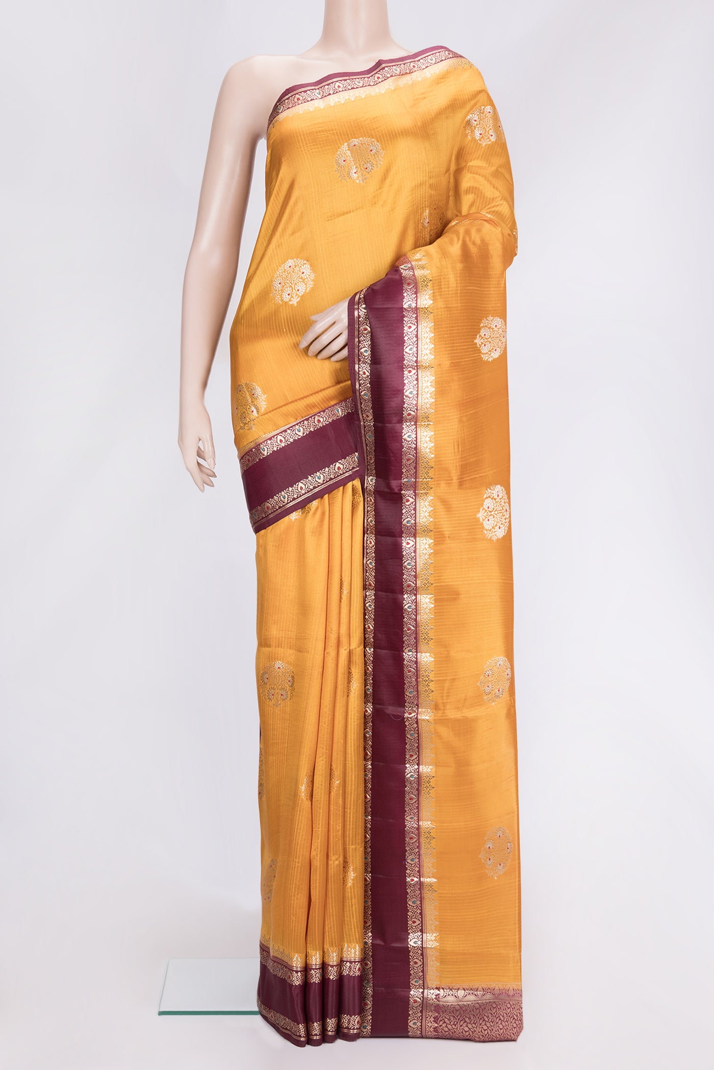 Mustard Dual Tone Tussar Silk Saree with Zari Butta on the body and Fancy Border.  displayed on a mannequin