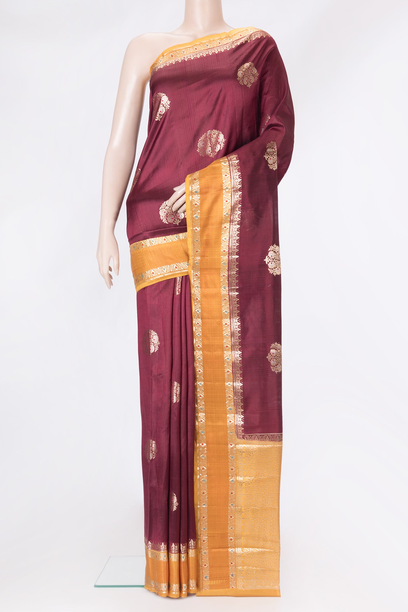 Coffee Brown Tussar Silk Saree with Zari And Thread Butta on the body and Zari Border.  displayed on a mannequin