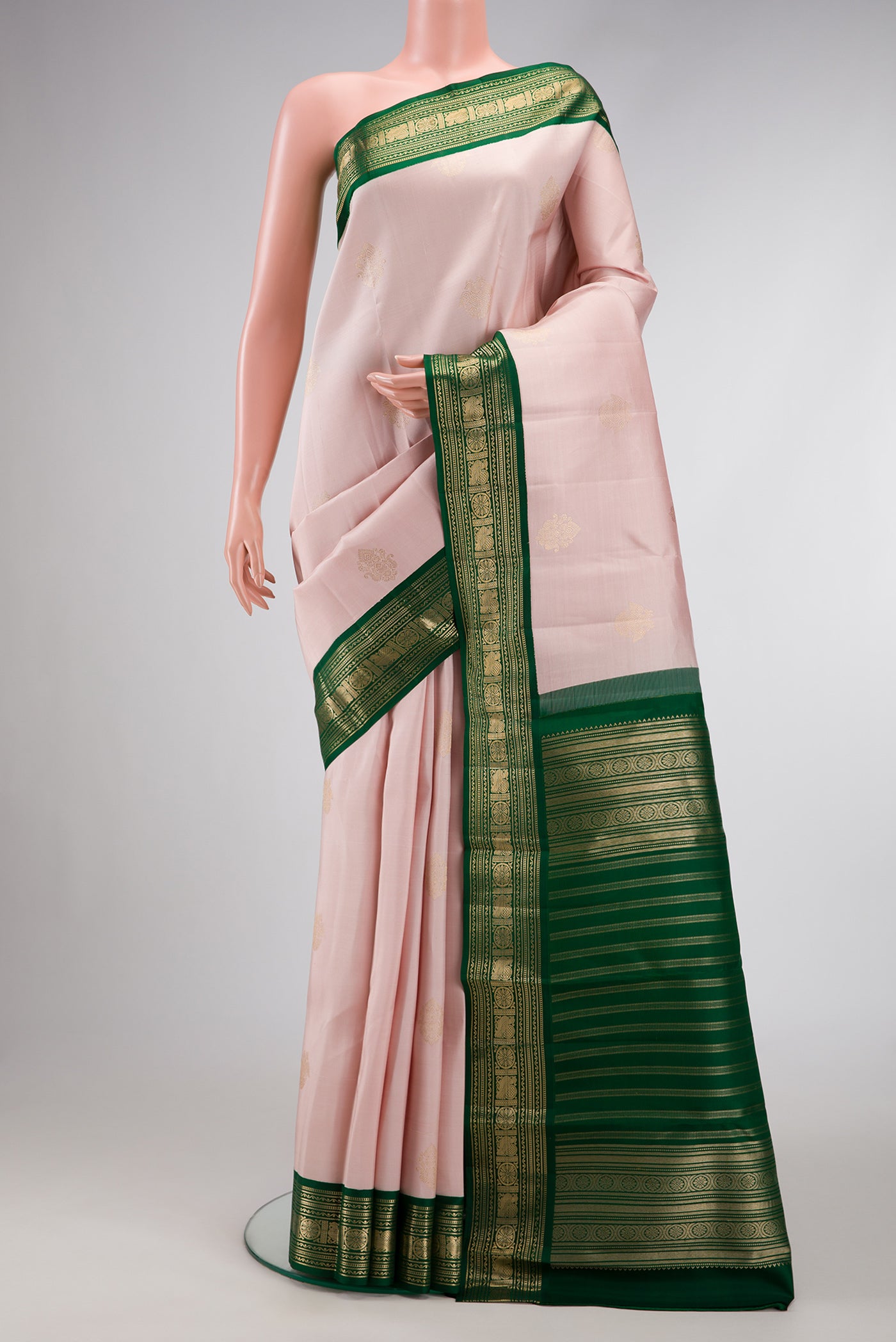 Rose Gold Dual Tone Kanchipuram Silk Saree with Zari Butta on the body and Zari Border.  displayed on a mannequin