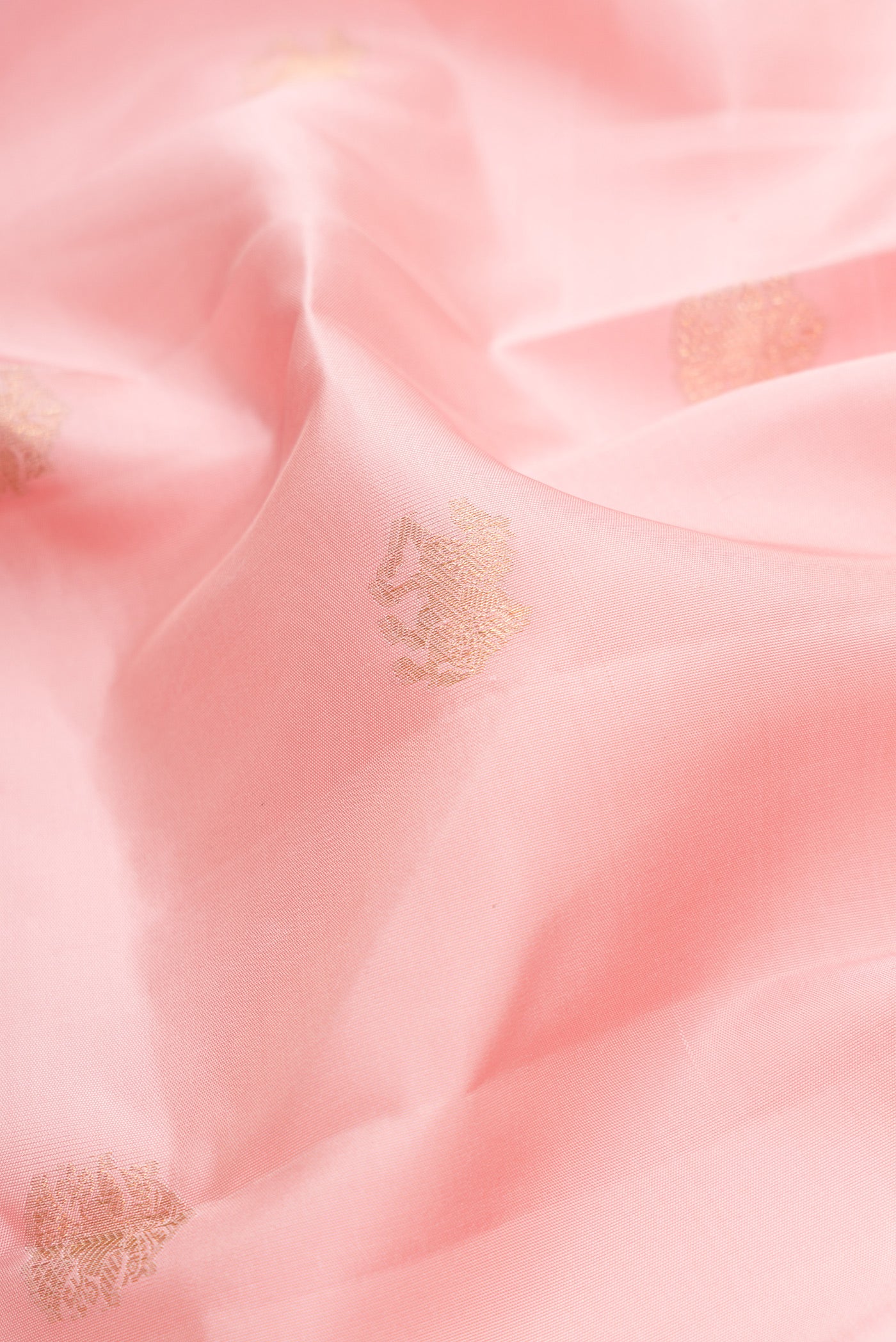 Close up of Pink Dual Tone Kanchipuram Silk Saree with Zari Butta on the body and Zari Border.  displaying folds