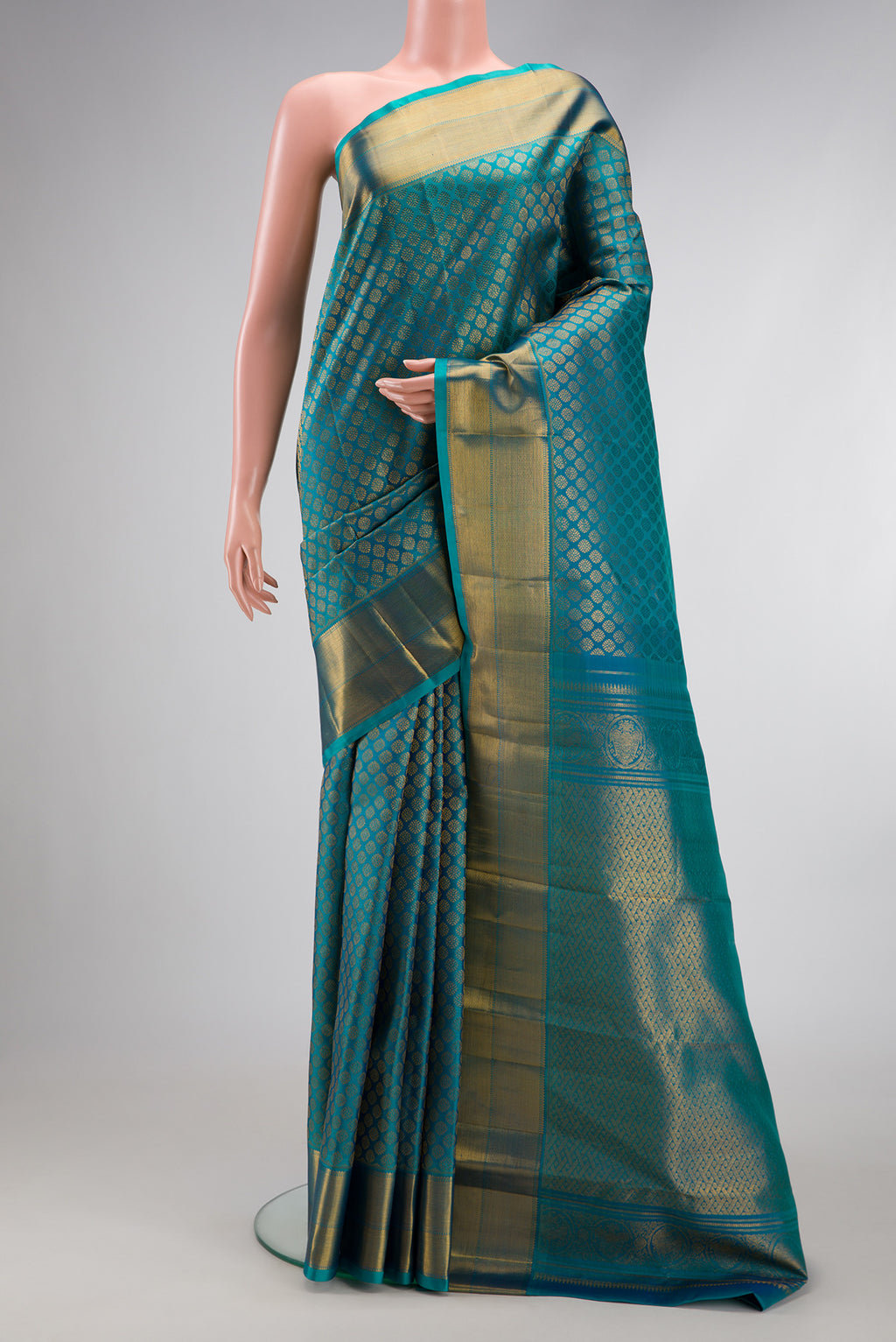 Peacock Blue Dual Tone Kanchipuram Silk Saree with Zari Brocade on the body and Zari Border.  displayed on a mannequin