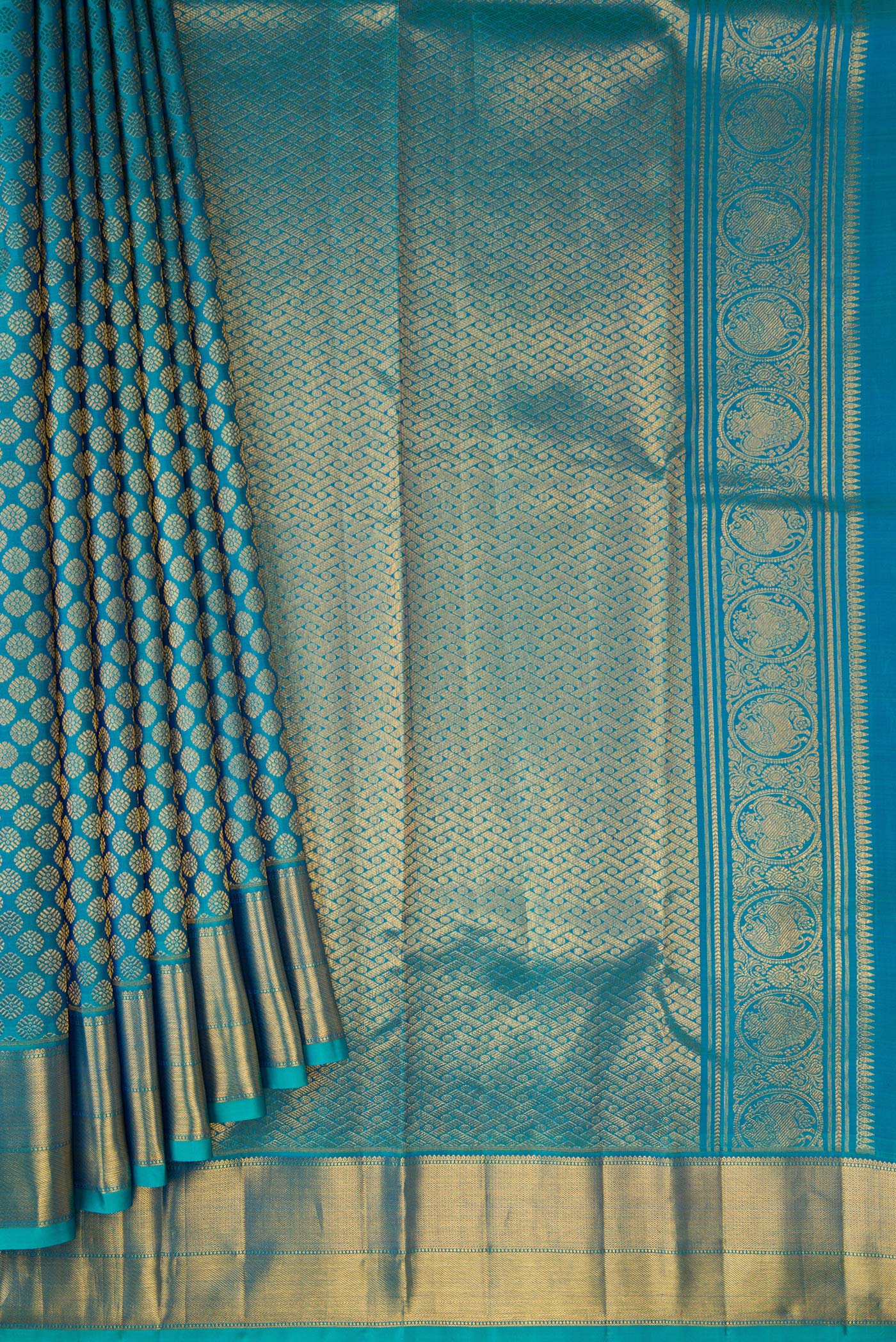 Pleats and pallu of Peacock Blue Dual Tone Kanchipuram Silk Saree with Zari Brocade on the body and Zari Border. 