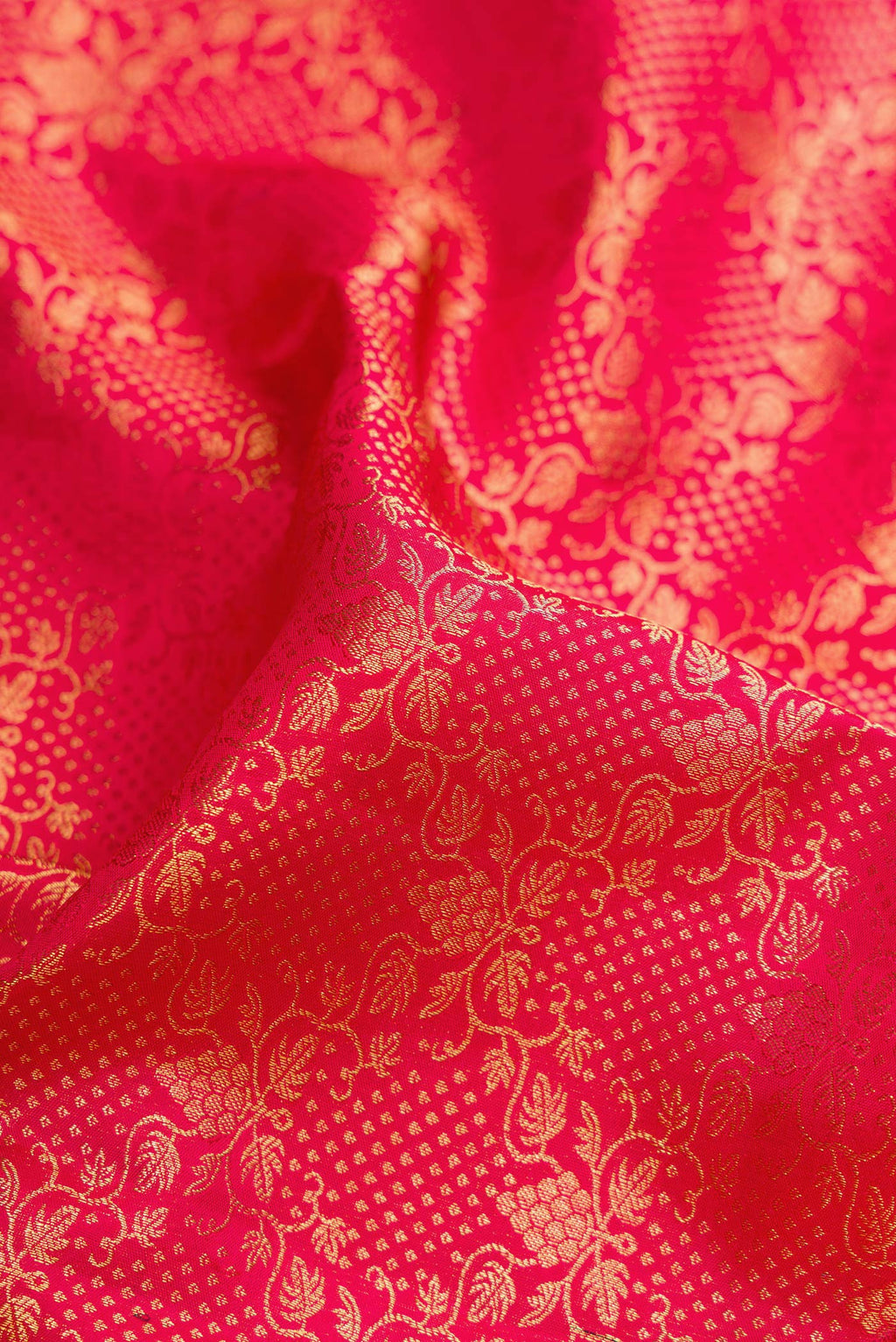 Close up of Dark Pink Dual Tone Kanchipuram Silk Saree with Zari Brocade on the body and Zari Border.  displaying folds