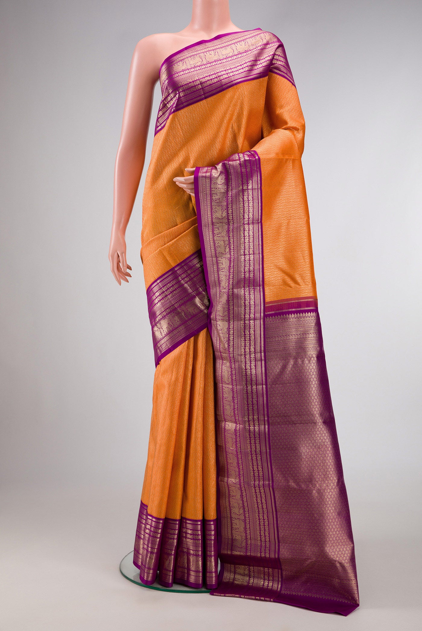 Orange Dual Tone Kanchipuram Silk Saree with Zari Brocade on the body and Zari Border.  displayed on a mannequin