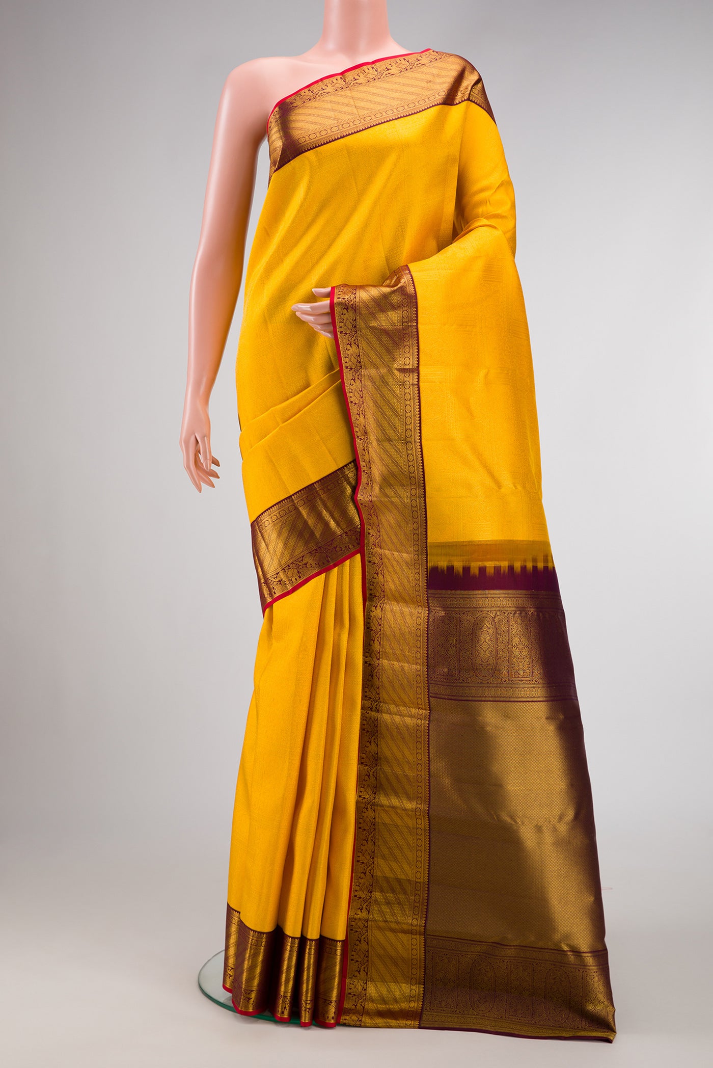Yellow Dual Tone Kanjivaram Silk Saree with Zari Brocade on the body and Zari Border.  displayed on a mannequin