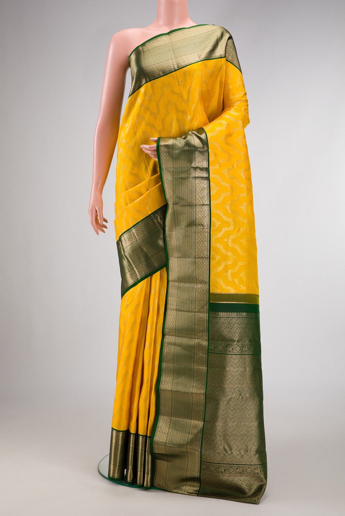 Yellow Dual Tone Kanjivaram Silk Saree with Zari Brocade on the body and Zari Border.  displayed on a mannequin