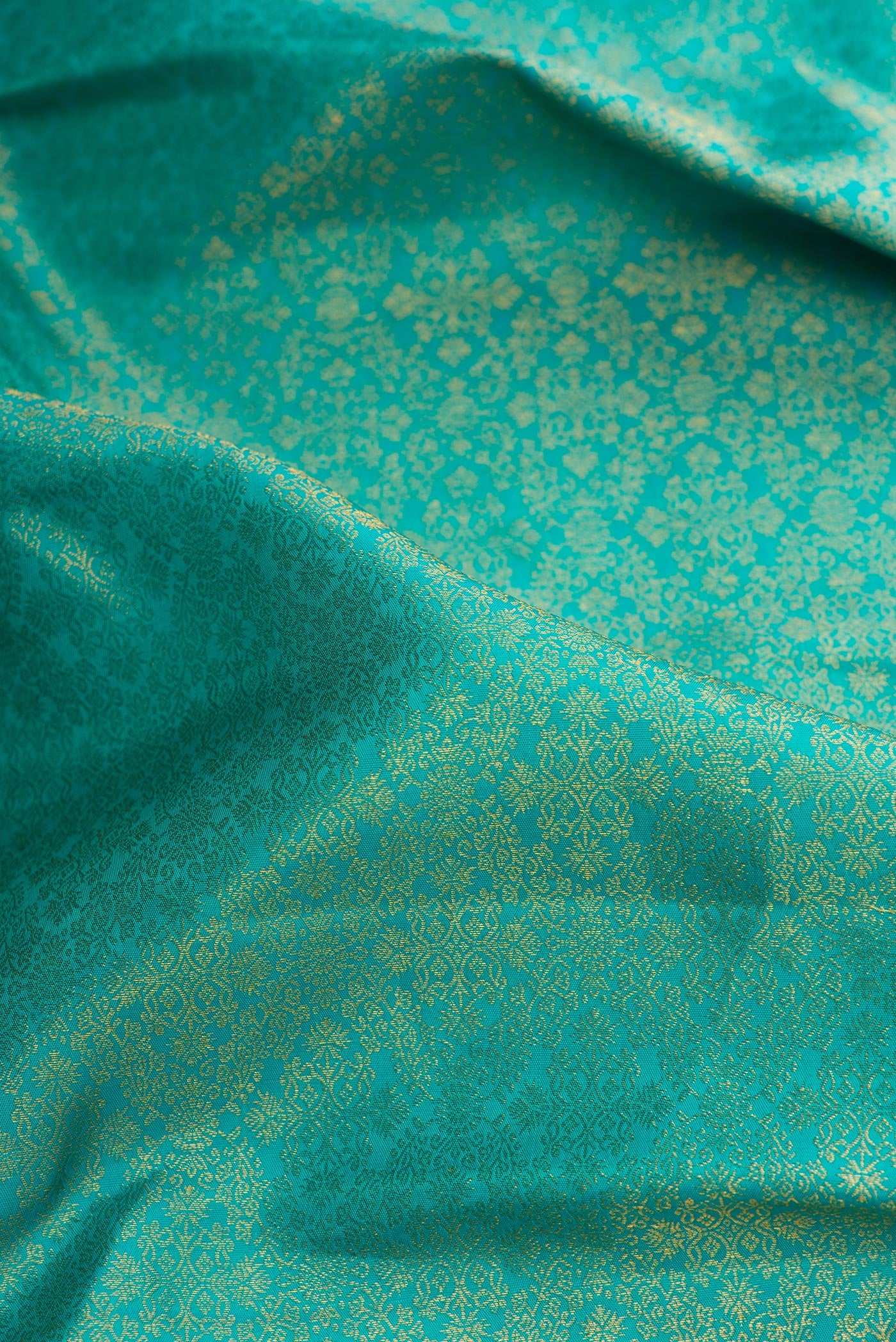 Close up of Sea Green Dual Tone Kanjivaram Silk Saree with Zari Brocade on the body and Zari Border.  displaying folds