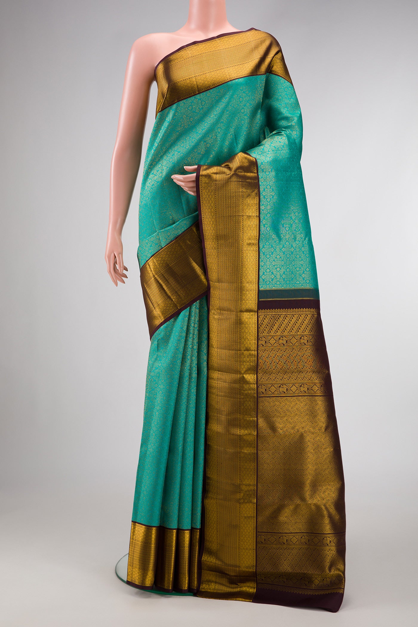 Sea Green Dual Tone Kanjivaram Silk Saree with Zari Brocade on the body and Zari Border.  displayed on a mannequin