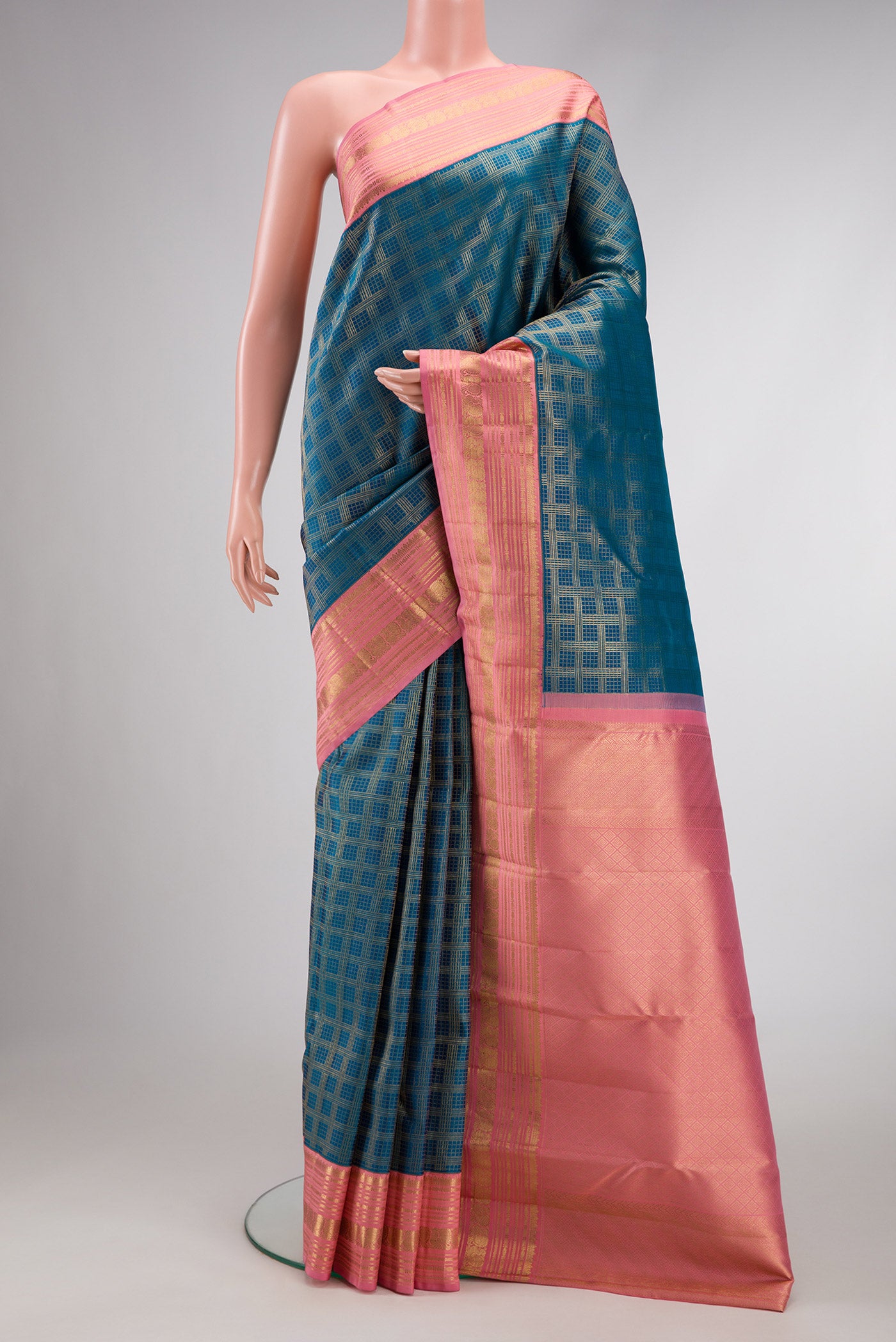 Peacock Blue Dual Tone Kanjivaram Silk Saree with Zari Brocade on the body and Zari Border.  displayed on a mannequin