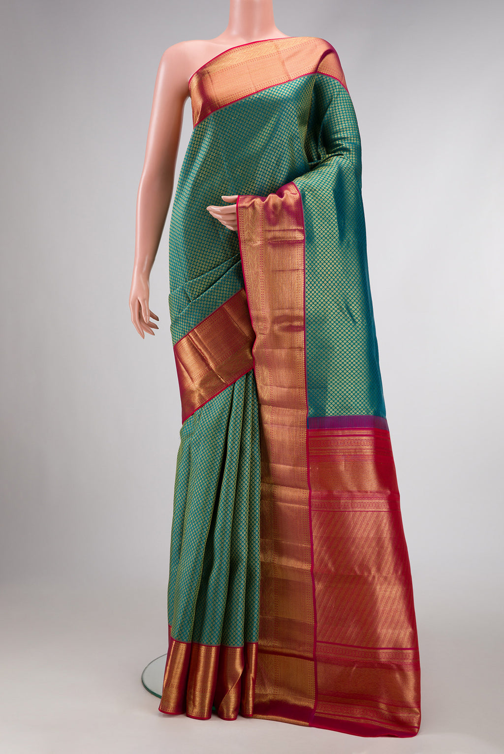 Green Dual Tone Kanjivaram Silk Saree with Zari Brocade on the body and Zari Border.  displayed on a mannequin