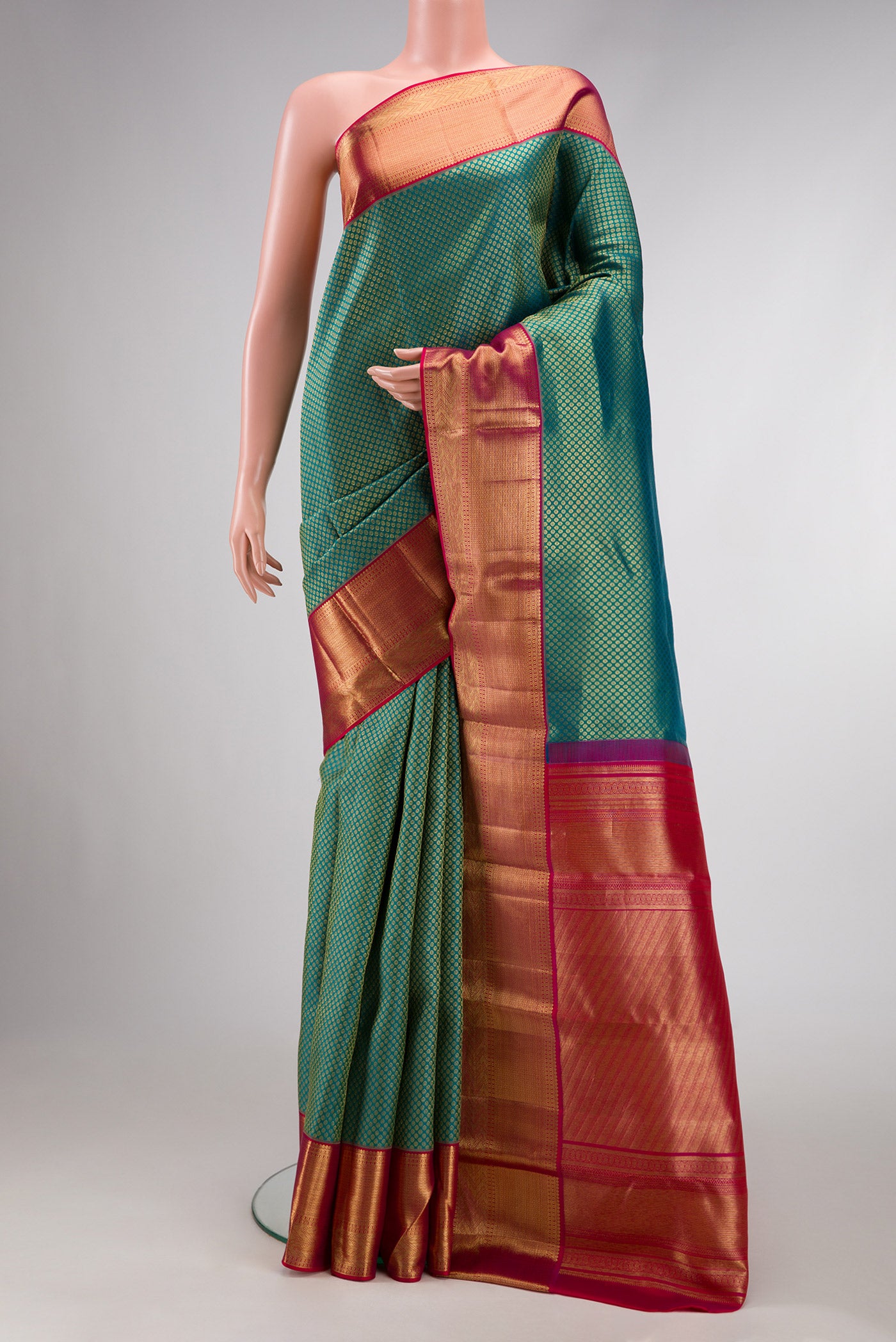 Green Dual Tone Kanjivaram Silk Saree with Zari Brocade on the body and Zari Border.  displayed on a mannequin