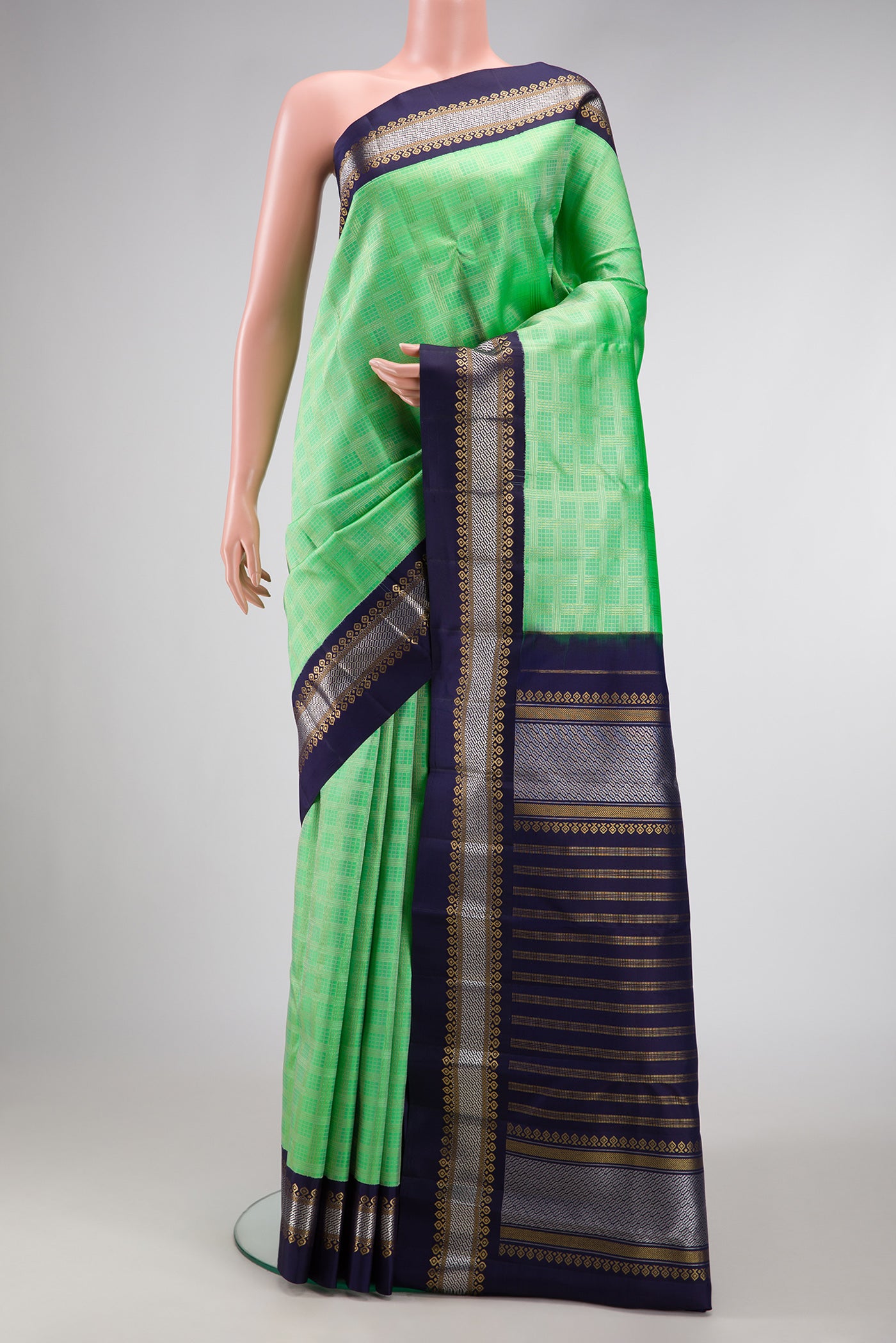 Parrot Green Dual Tone Kanjivaram Silk Saree with Zari Brocade on the body and Zari Border.  displayed on a mannequin