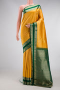 Mustard Kanjivaram Silk Saree with Zari Brocade on the body and Zari Border.  displayed on a mannequin