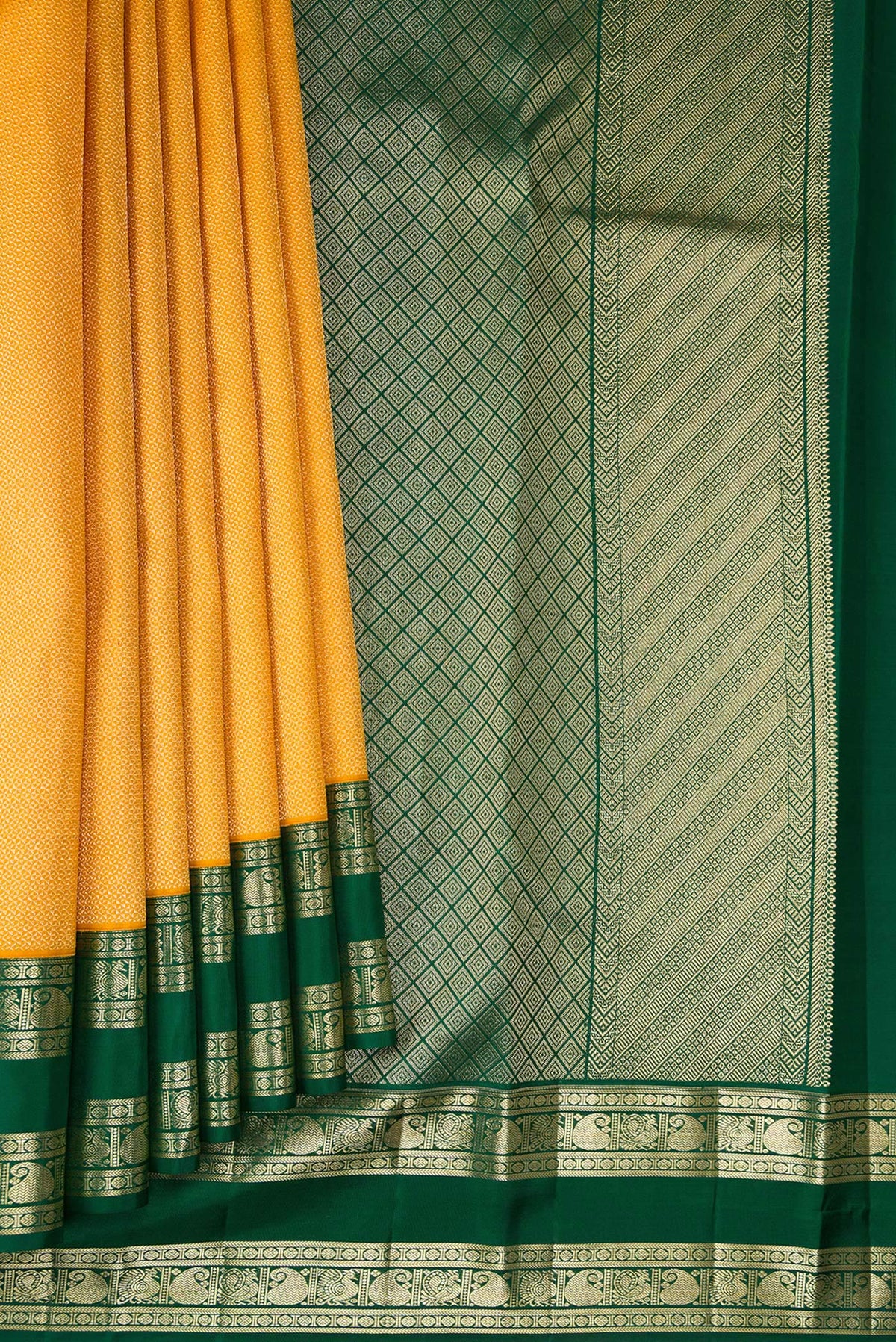 Pleats and pallu of Mustard Kanjivaram Silk Saree with Zari Brocade on the body and Zari Border. 