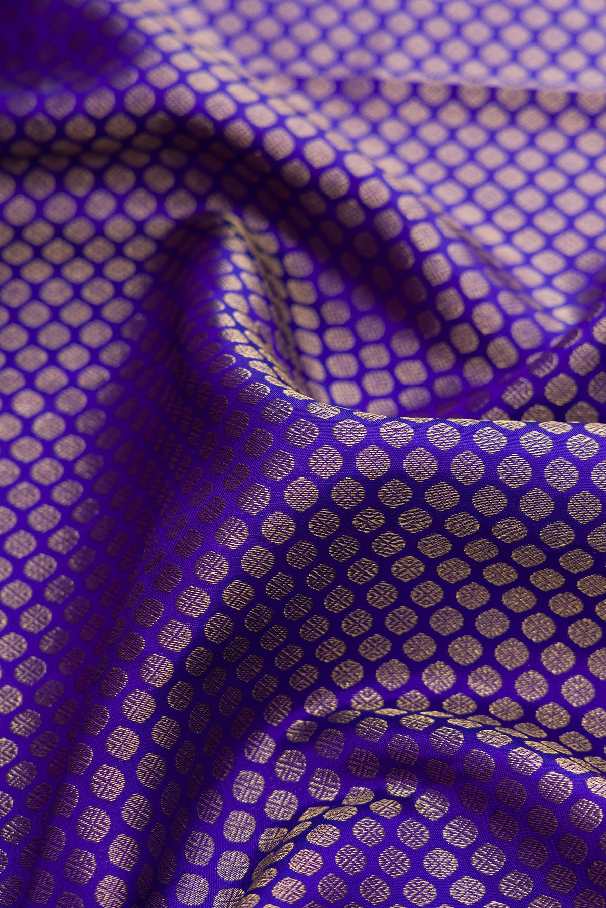 Close up of Royal Blue Dual Tone Kanjivaram Silk Saree with Zari Brocade on the body and Zari Border.  displaying folds