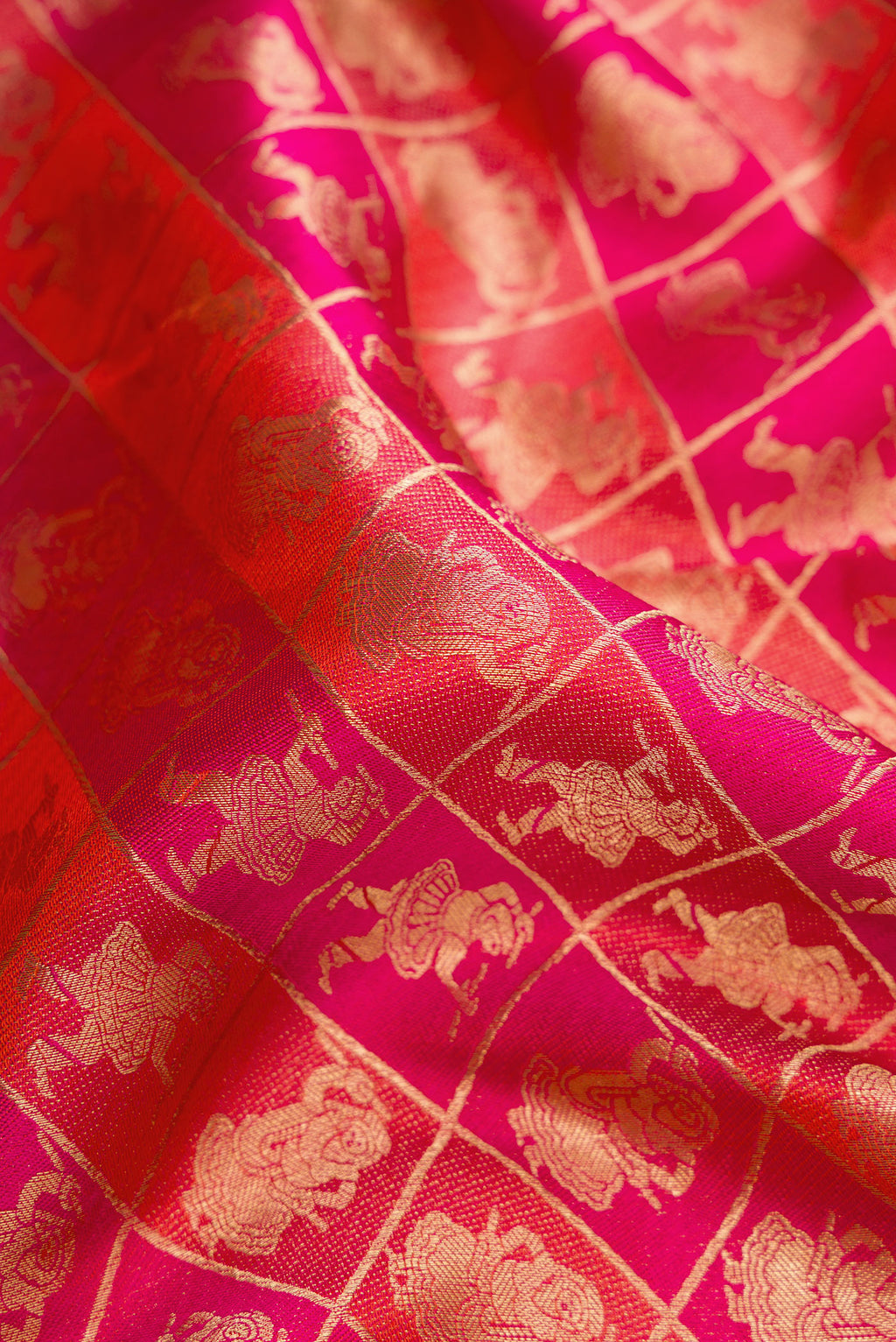 Close up of Orange Dual Tone Kanchipuram Silk Saree with Zari Brocade on the body and Zari Border.  displaying folds