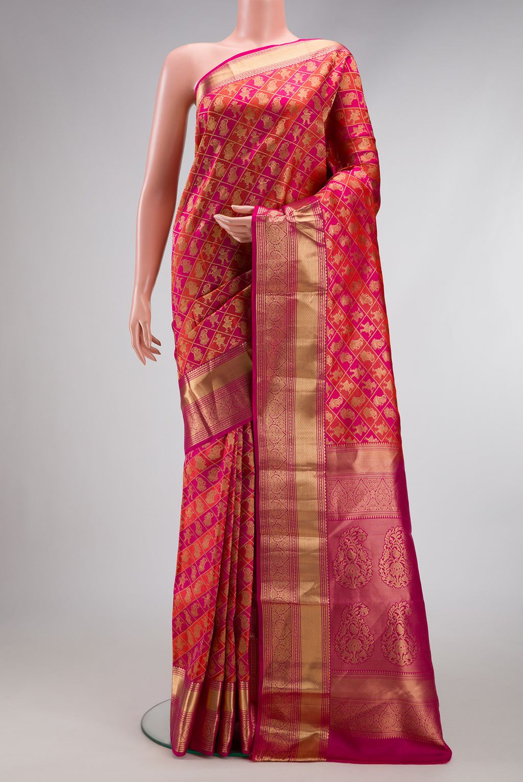 Orange Dual Tone Kanchipuram Silk Saree with Zari Brocade on the body and Zari Border.  displayed on a mannequin