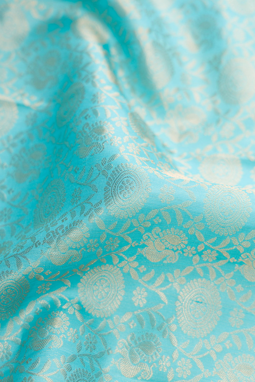Close up of Sky Blue Dual Tone Kanjivaram Silk Saree with Zari Brocade on the body and Zari Border.  displaying folds