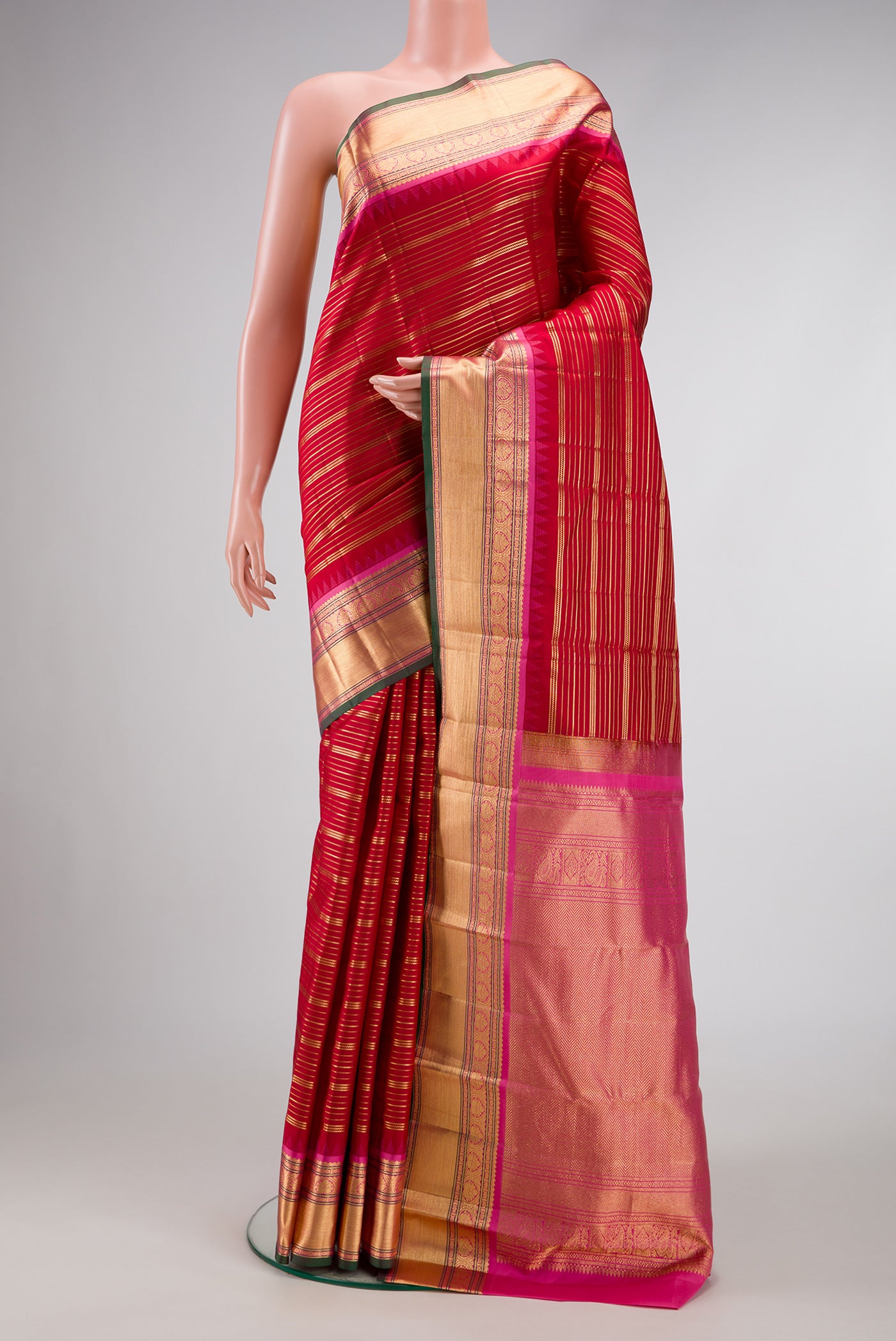 Red Dual Tone Kanjivaram Silk Saree with Stripes on the body and Zari Border.  displayed on a mannequin