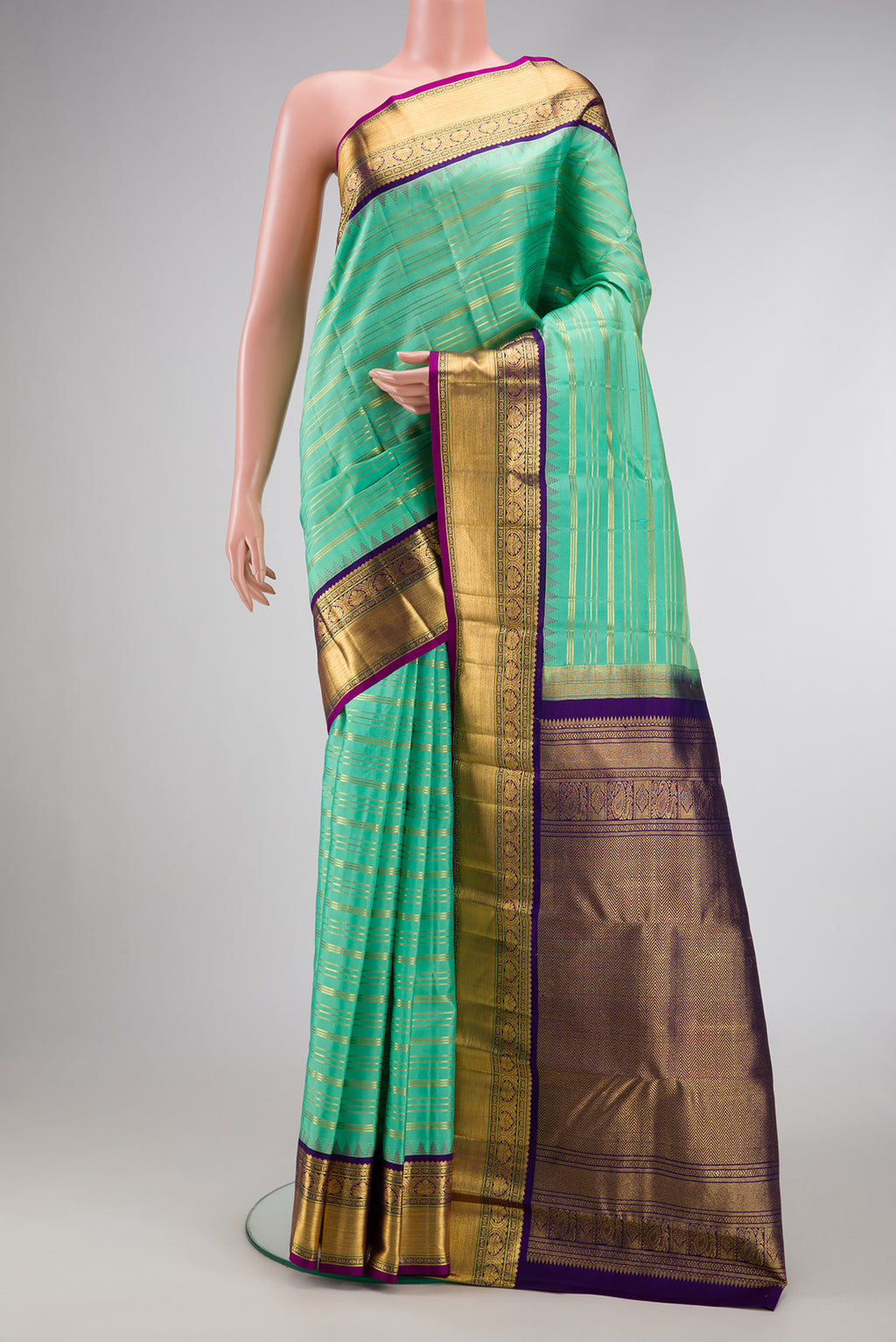 Sea Green Dual Tone Kanjivaram Silk Saree with Stripes on the body and Zari Border.  displayed on a mannequin