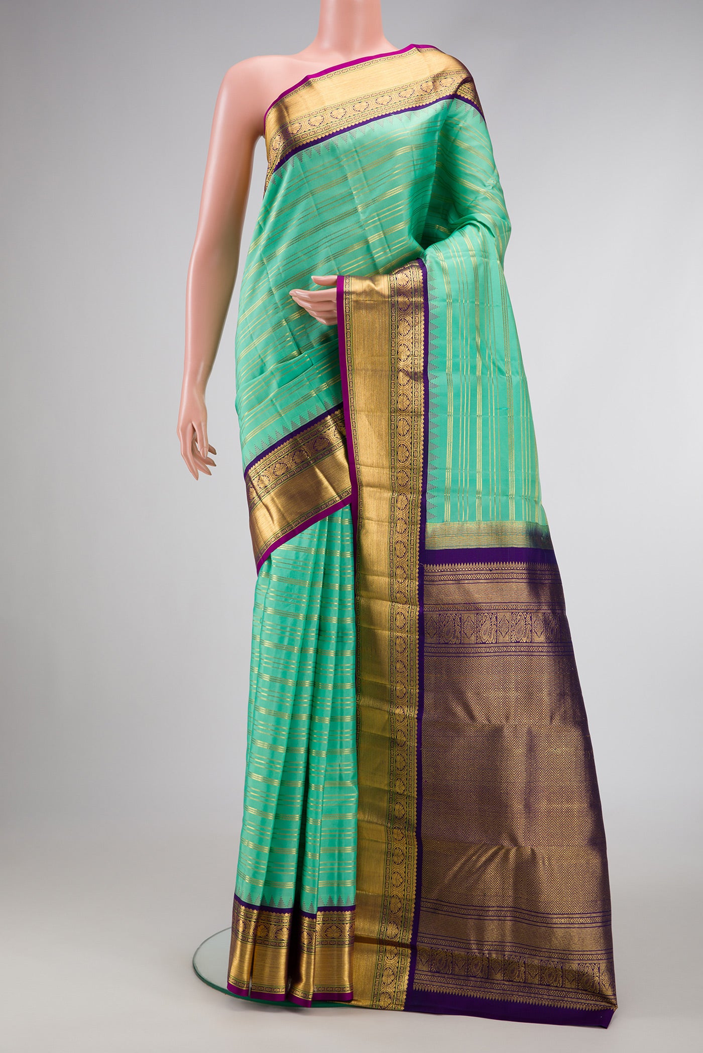 Sea Green Dual Tone Kanjivaram Silk Saree with Stripes on the body and Zari Border.  displayed on a mannequin