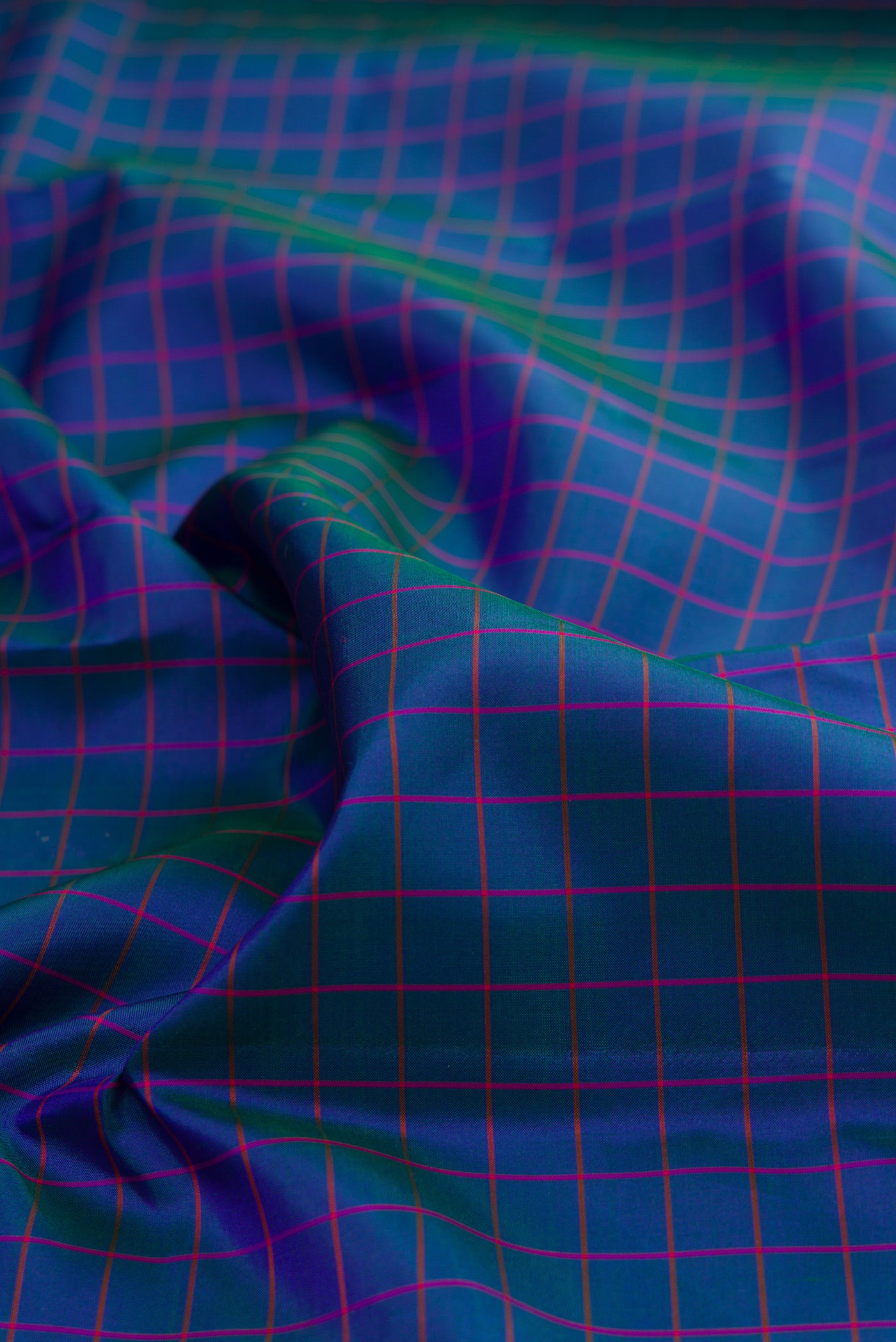 Close up of Pure Silk Peacock Blue Kanjivaram Saree with Checked design on the body and Zari Border.  displaying folds