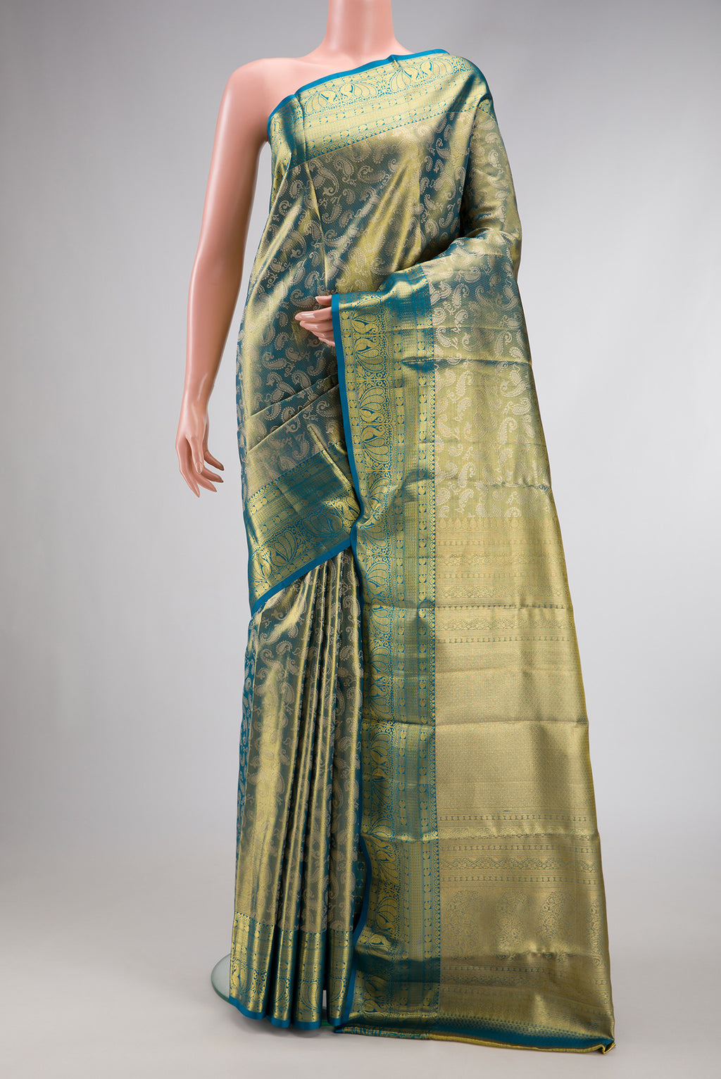 Green Dual Tone Kanchipuram Tissue Silk Saree with Zari Brocade on the body and Zari Border.  displayed on a mannequin