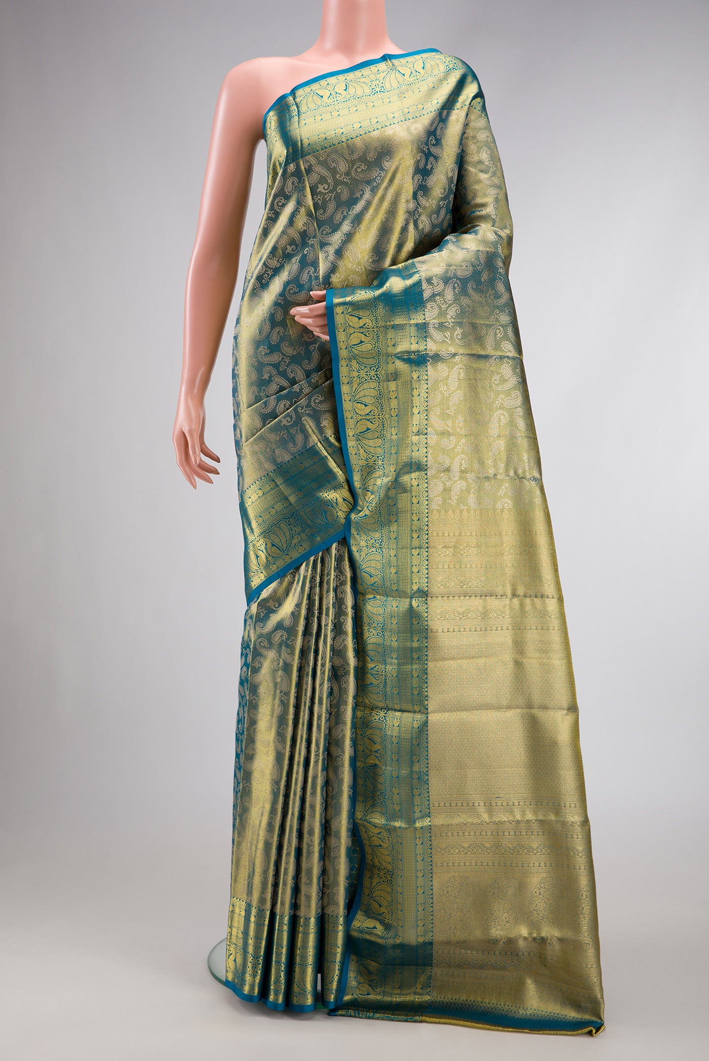 Green Dual Tone Kanchipuram Tissue Silk Saree with Zari Brocade on the body and Zari Border.  displayed on a mannequin